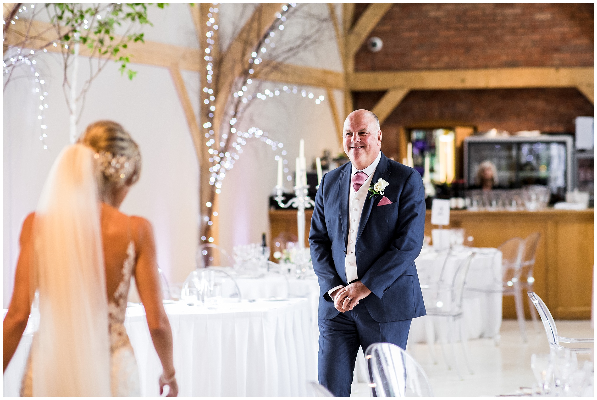 first look between bride and brides father, he is smiling profusely.