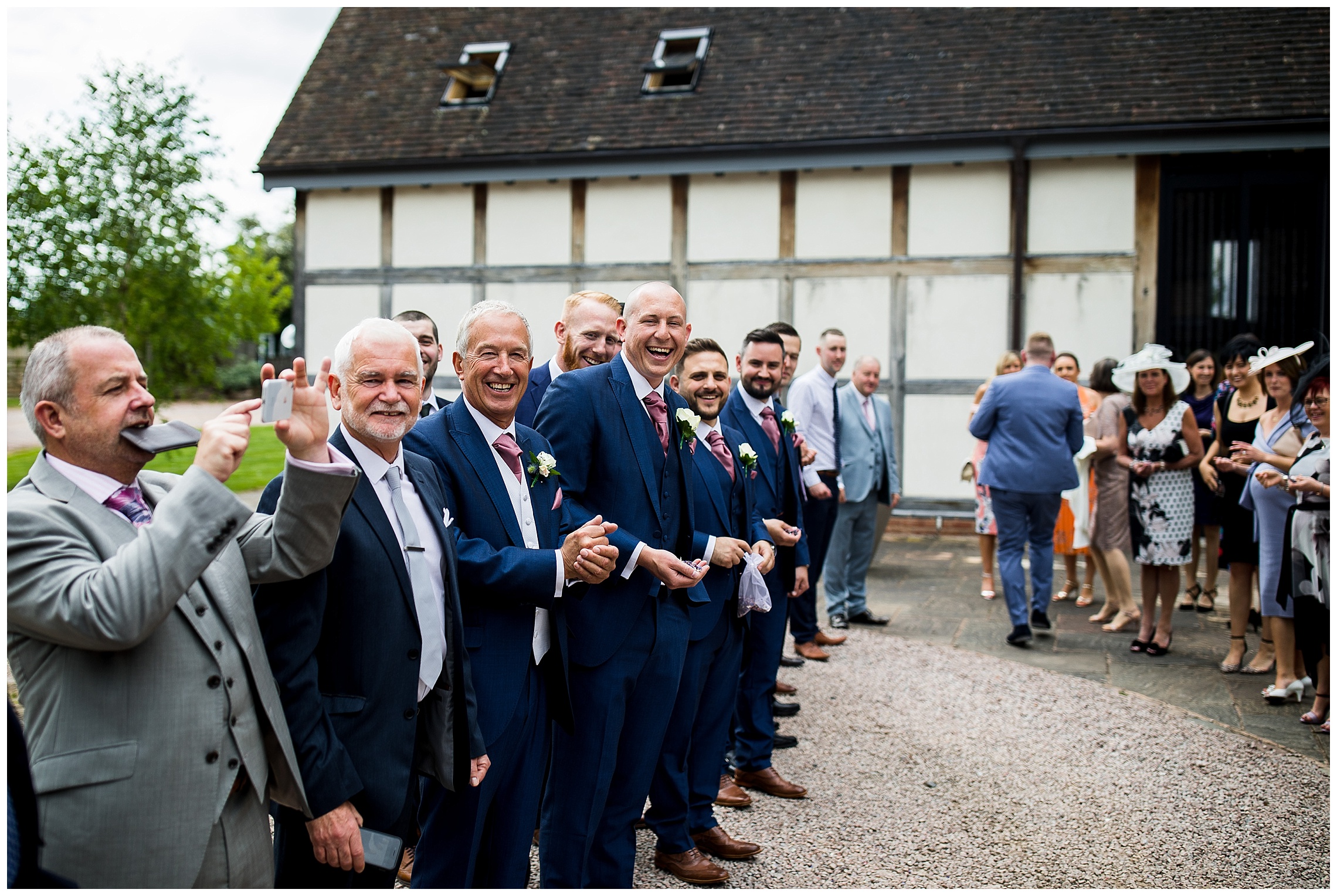 guests smiling in suits