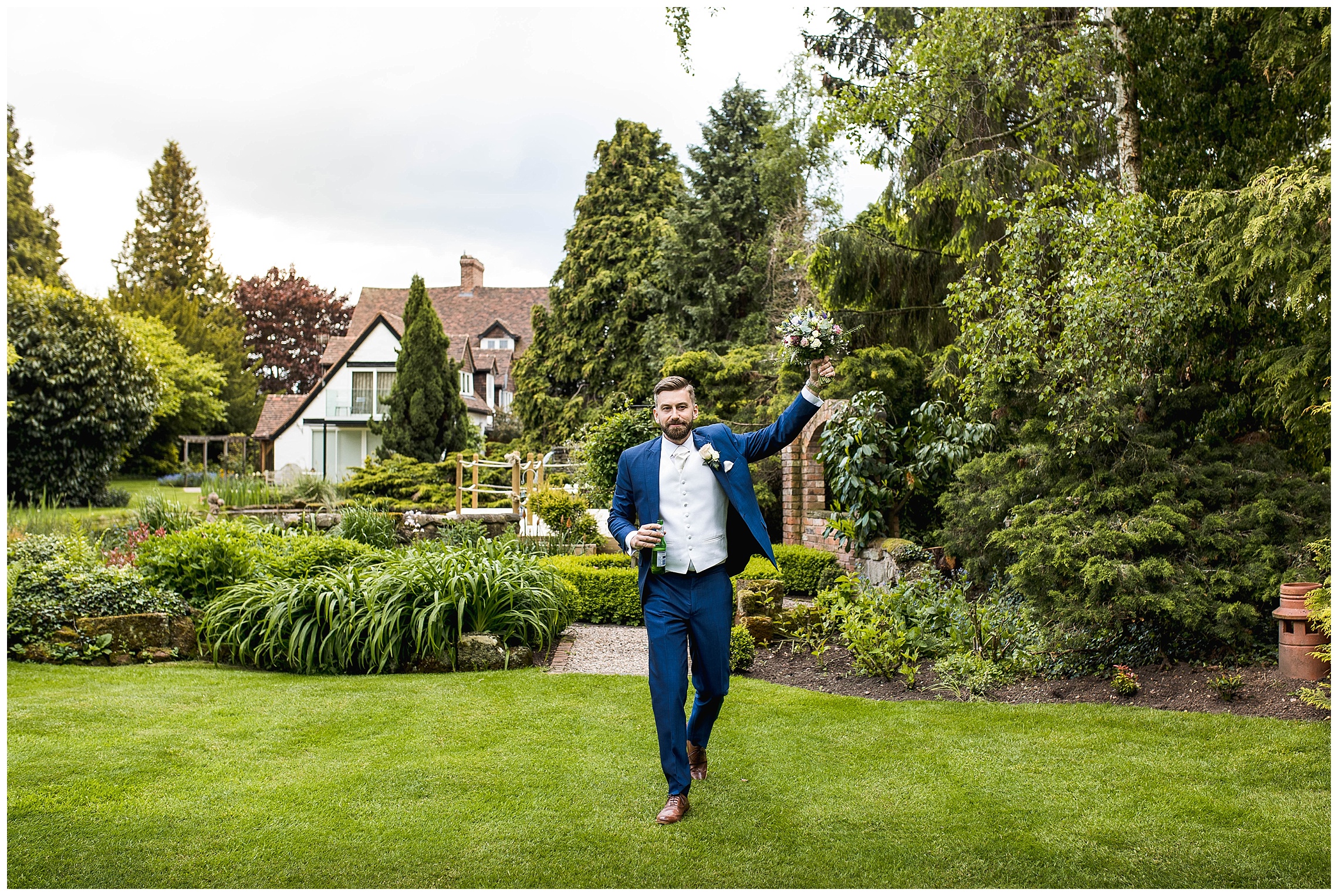 groom walking carrying brides pink wedding bouquet at redhouse barn