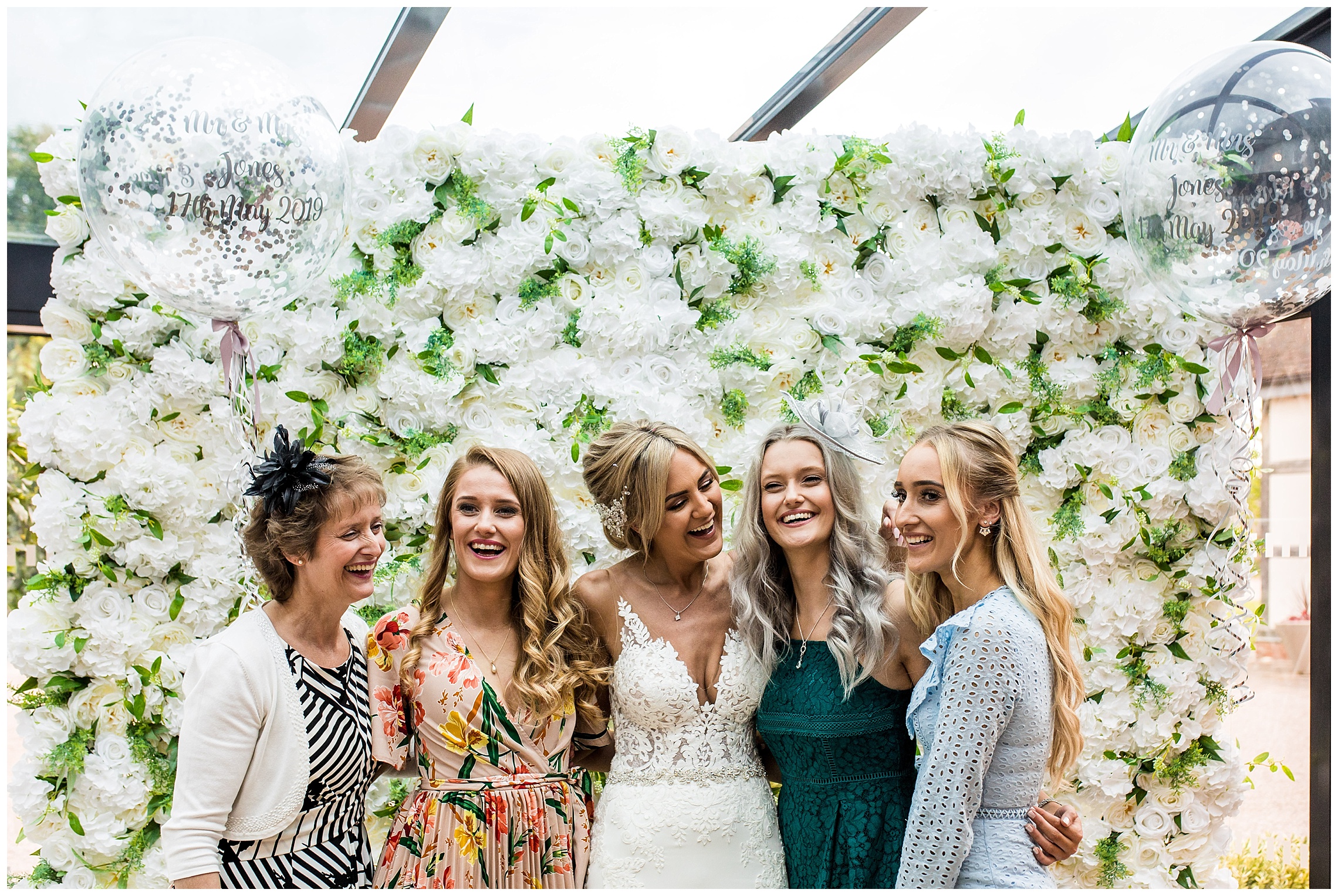 flower wall with wedding guests