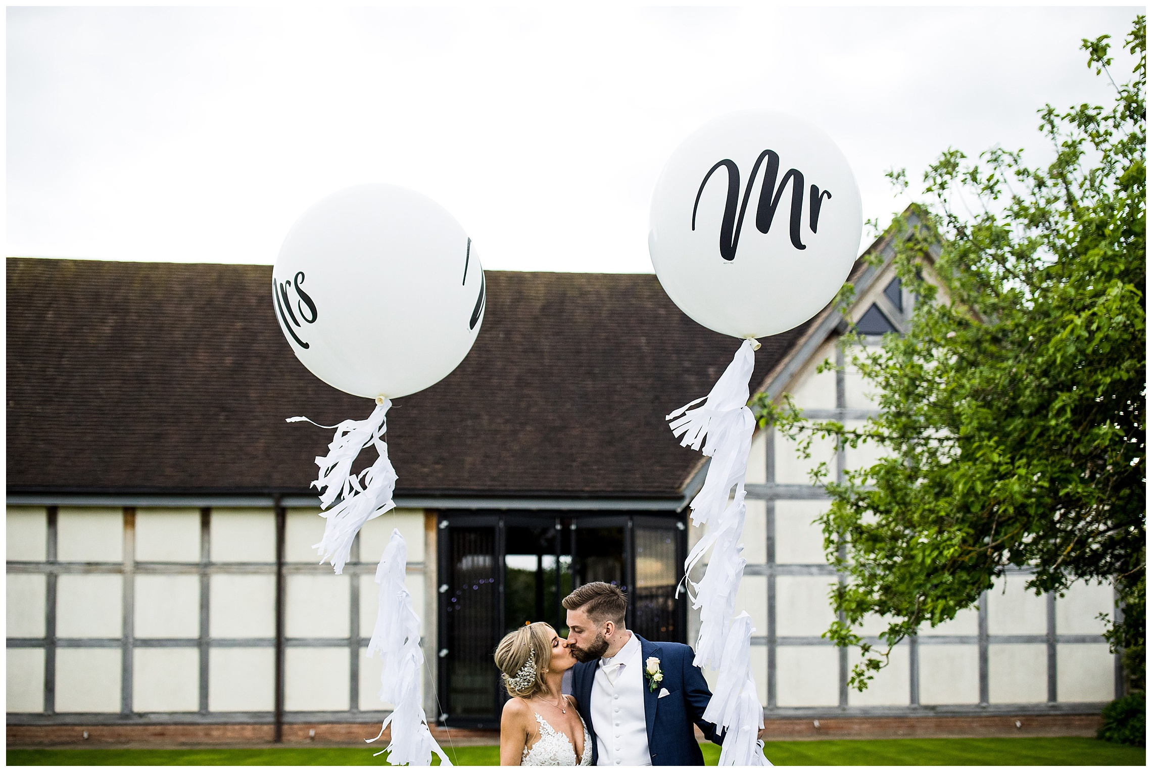 mr and mrs balloon with bride and groom outside redhouse barn