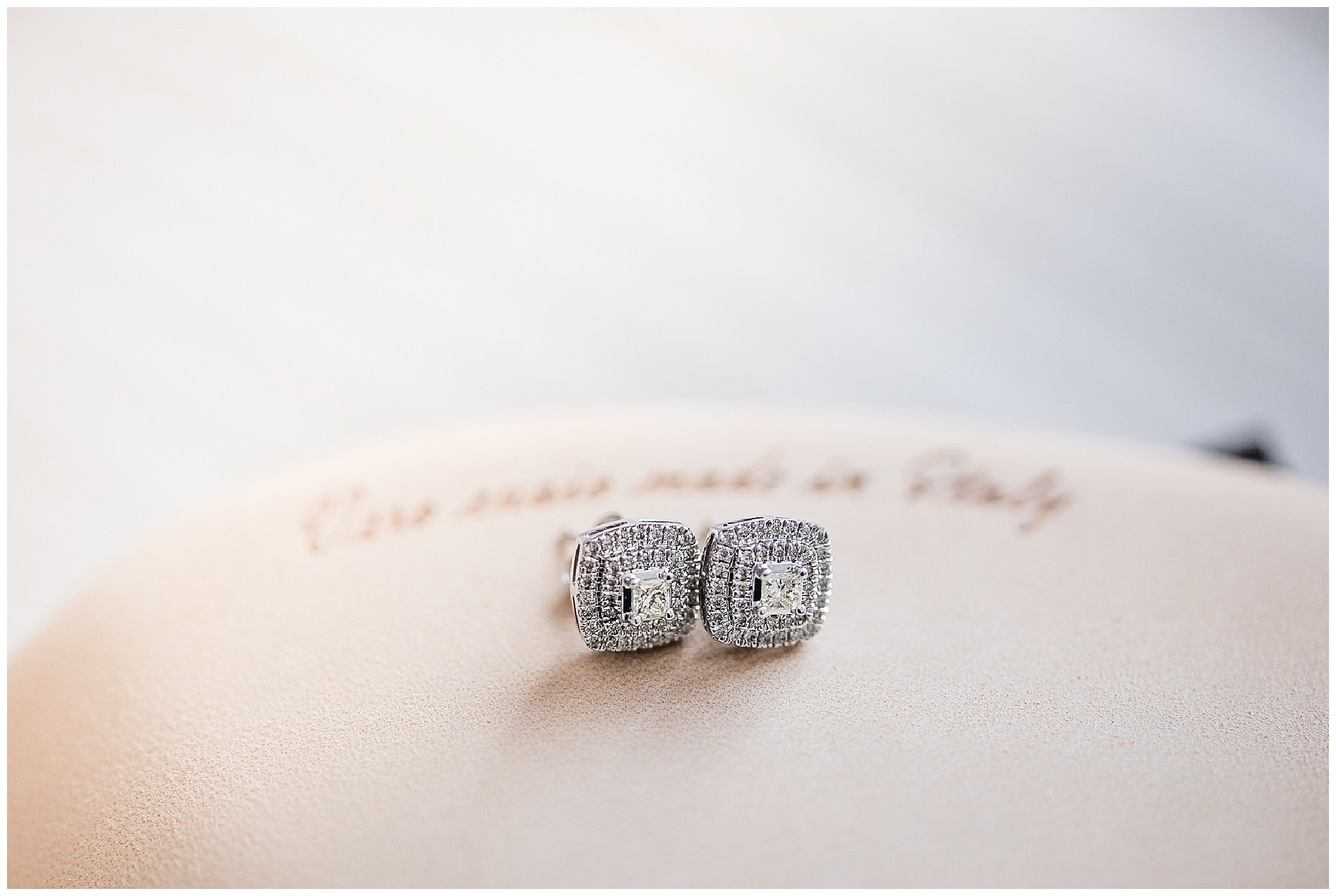 Diamond wedding earrings on bottom of designer shoes