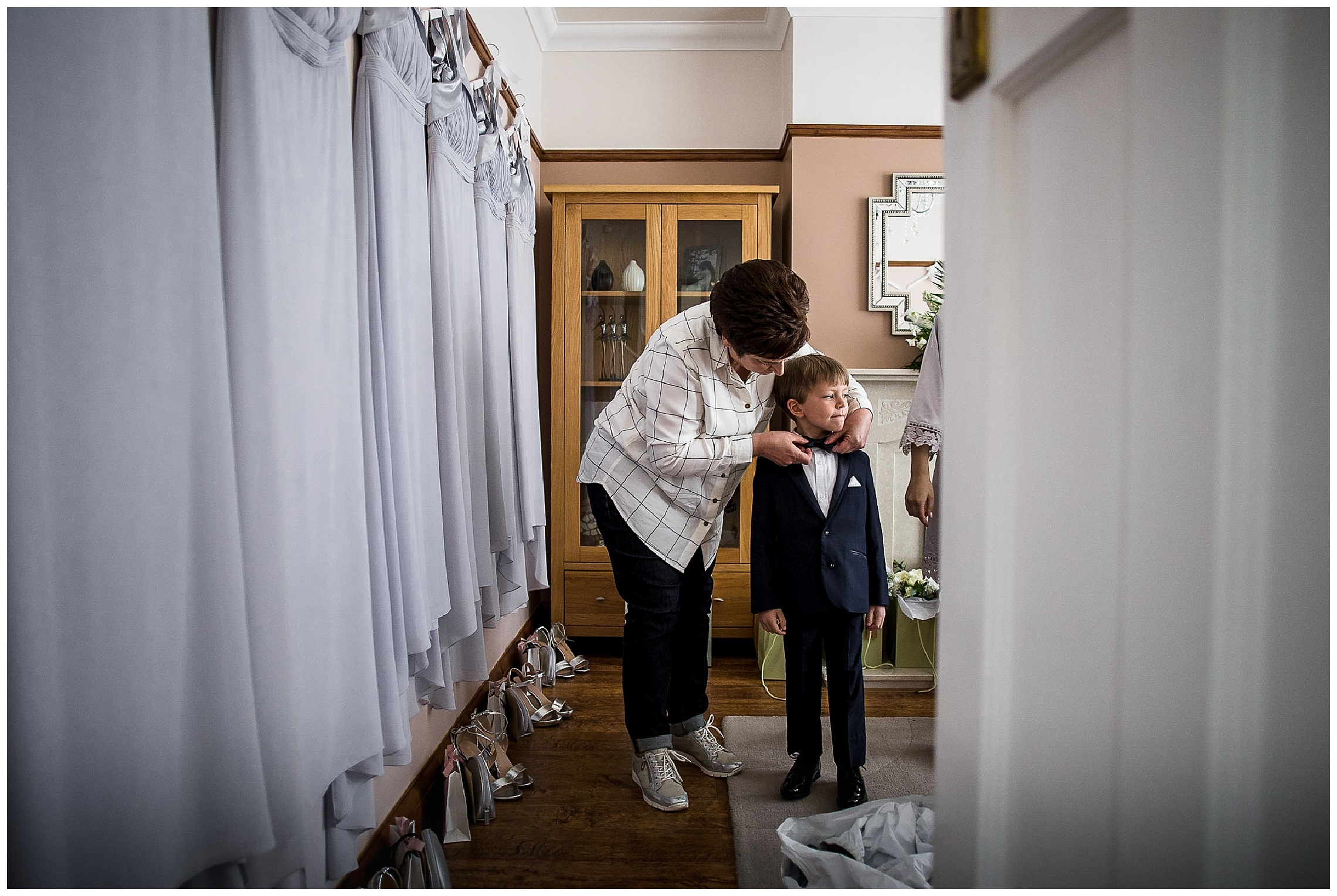 mother of the bride alters suit of young usher and his bow tie