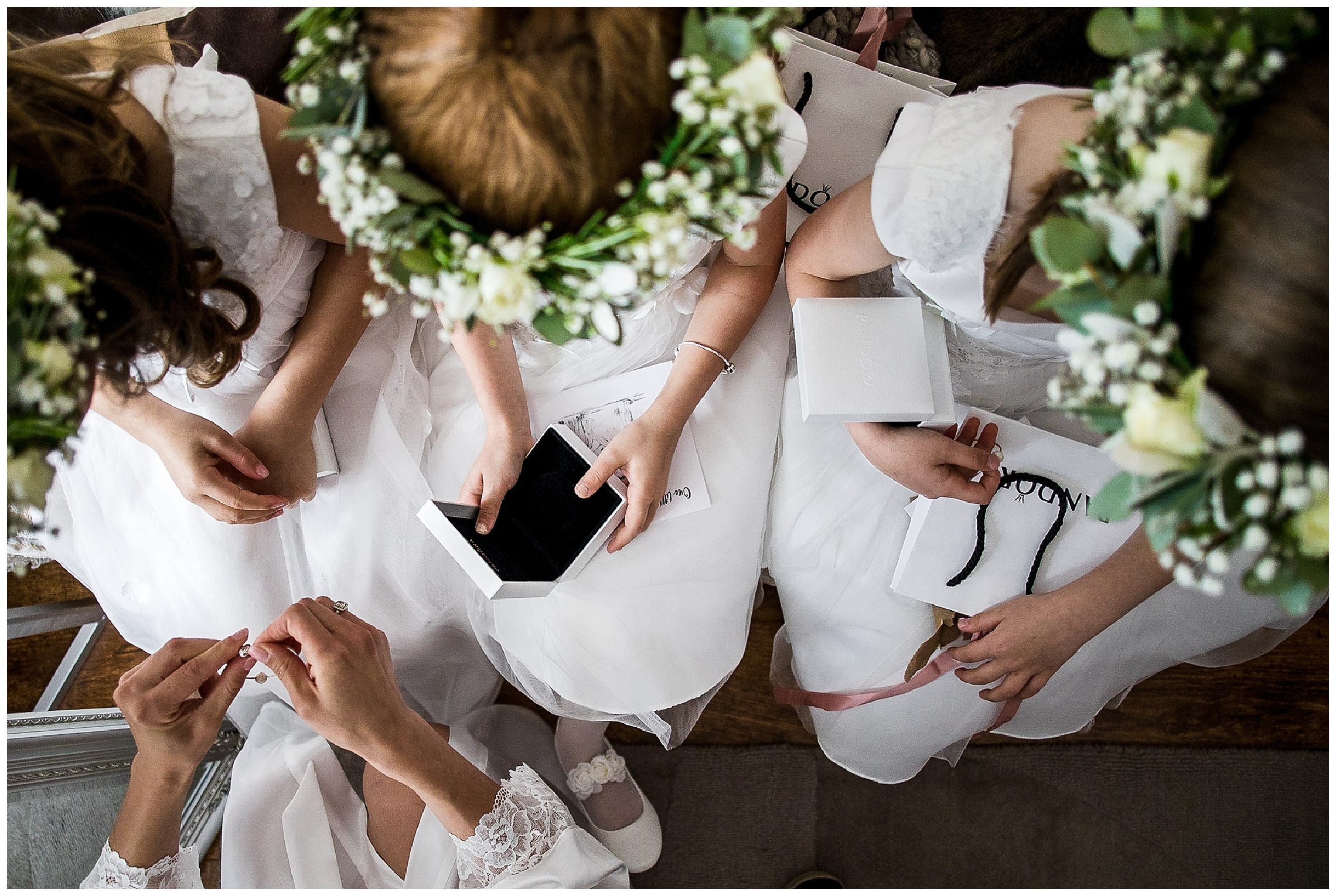 flower girls opening gifts on white sofa in dress s