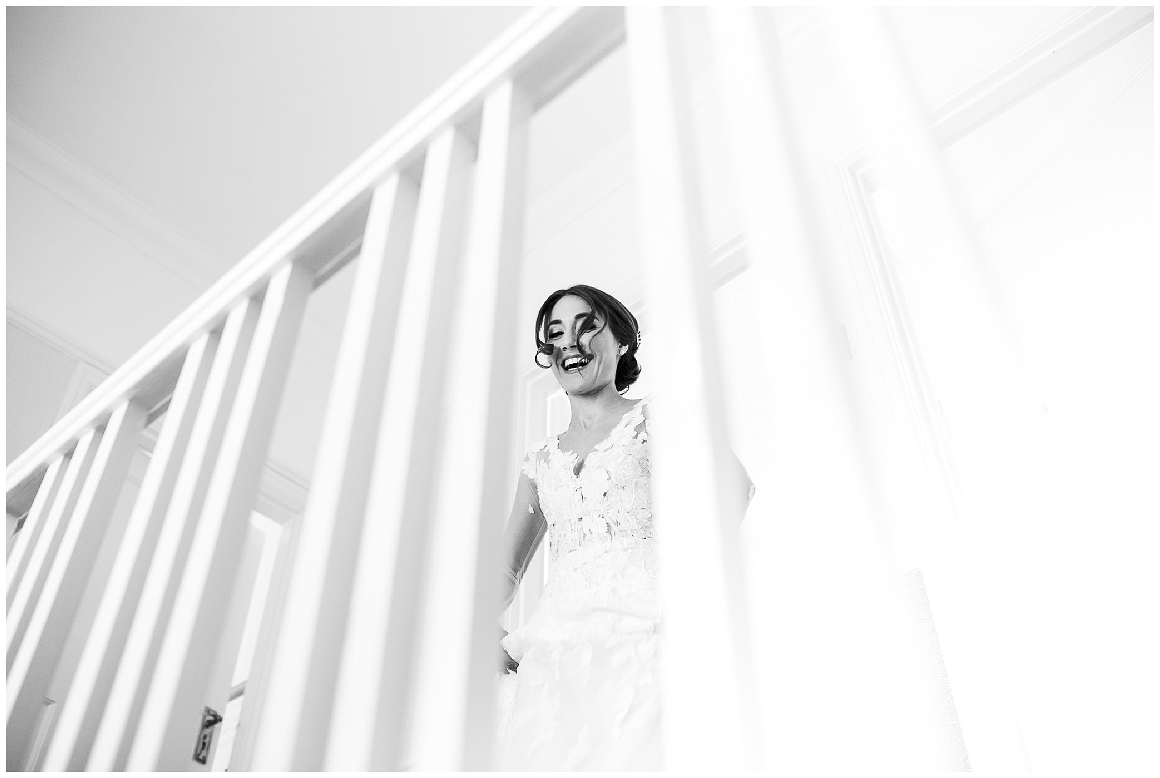 bride in wedding dress comes out of bedroom and laughs