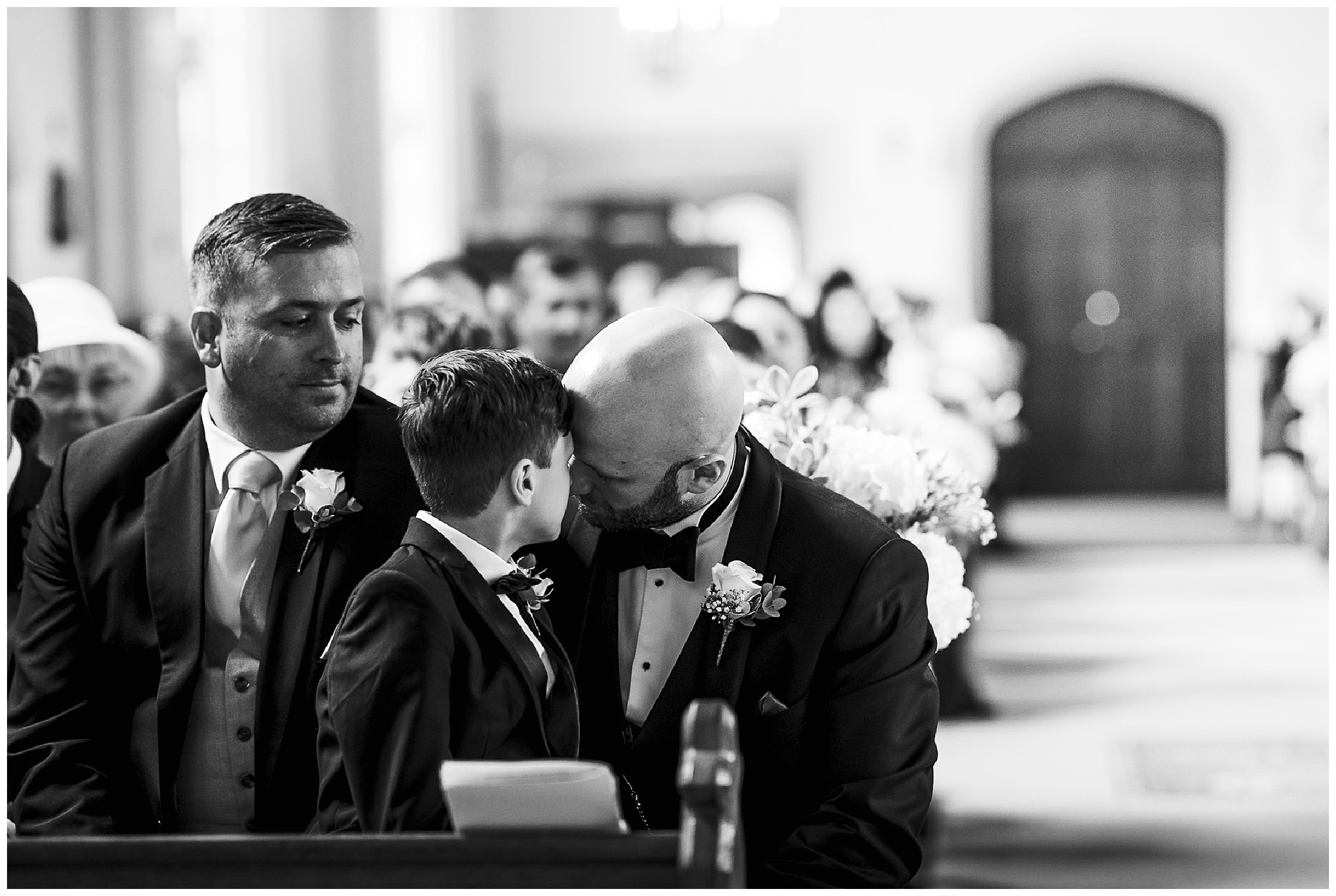 groom and son touch heads and take a quiet moment