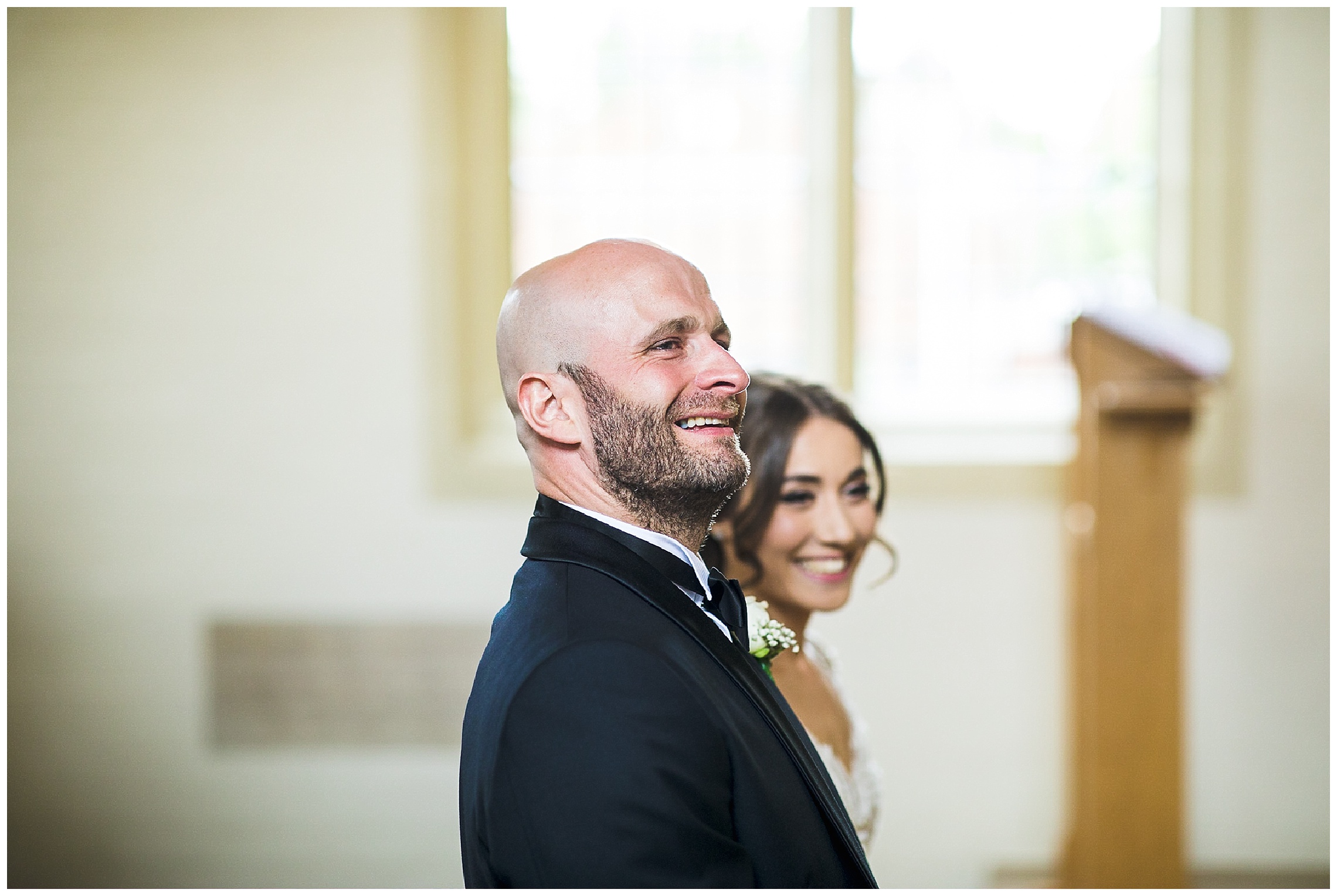 bride and groom smiling during wedding ceremony