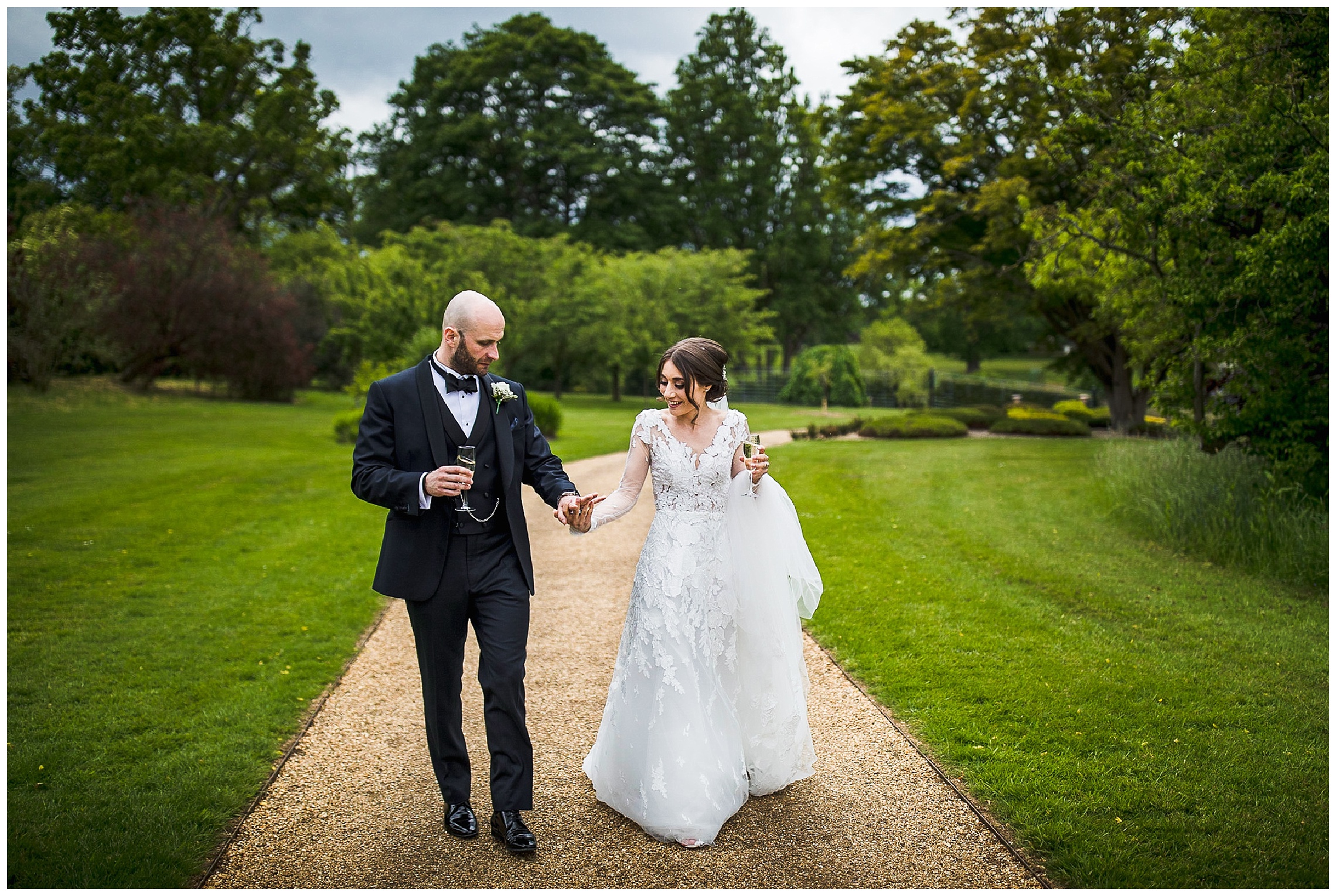 bride and groom walking hand in hand through woburn green gardens