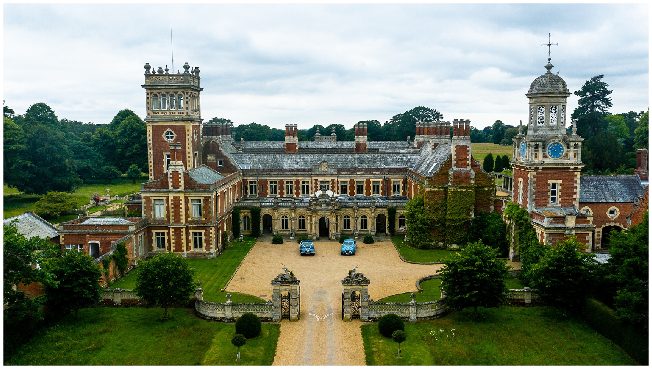 aerial shot of somerleyton hall with two blue wedding cars outside