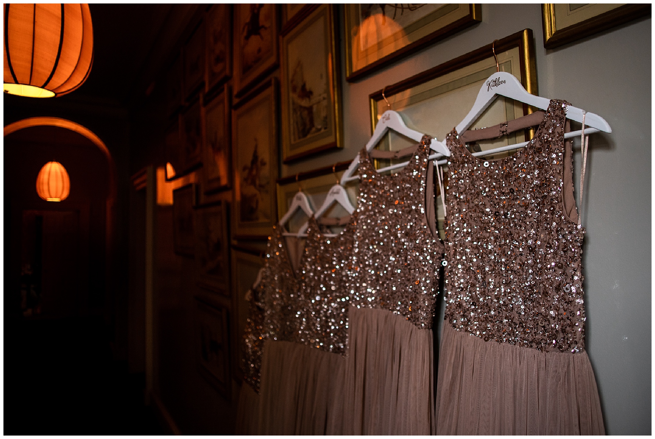 pink sequin bridesmaids dresses hanging on picture frames