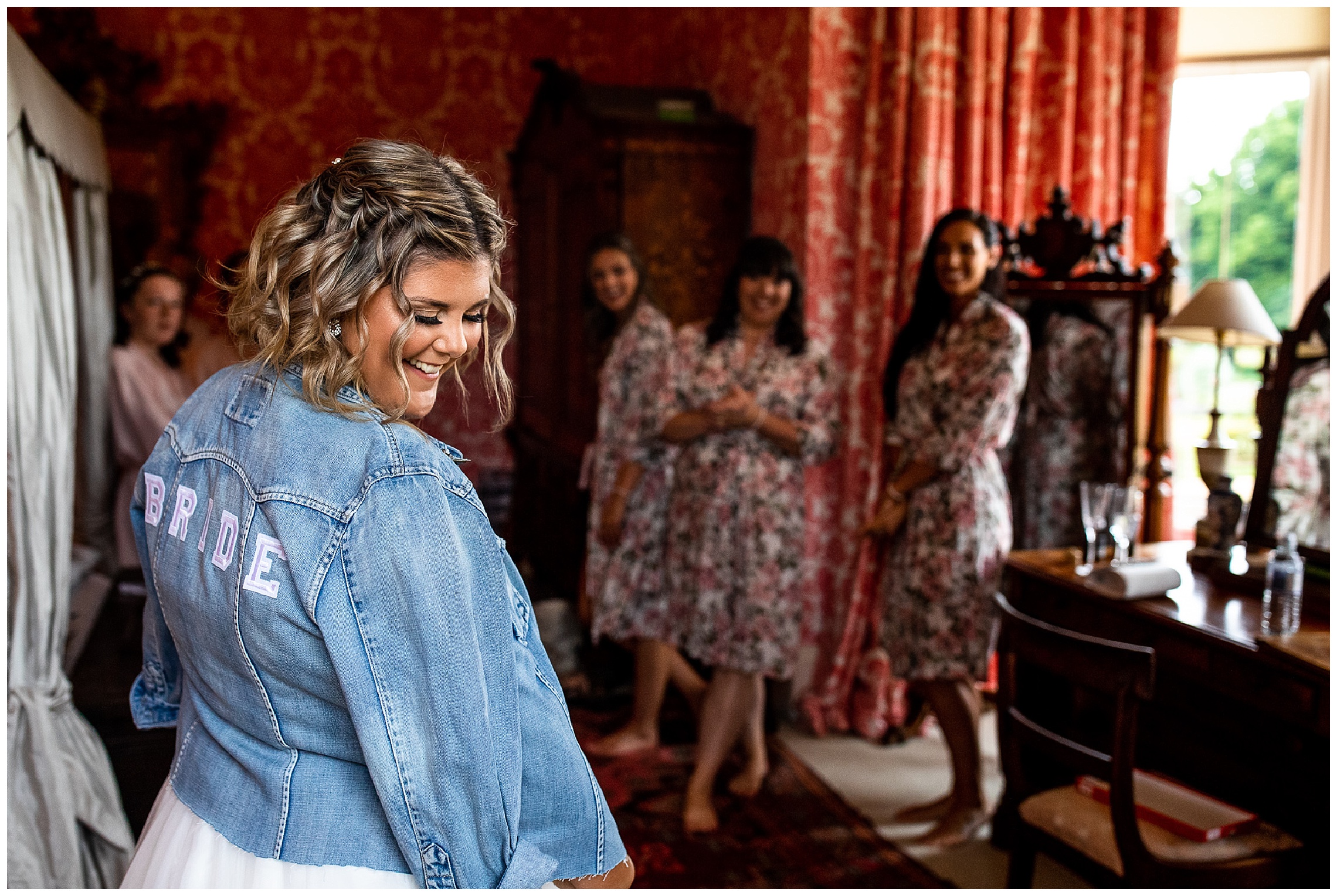 bride in white dress with denim jacket personalised with the word bride