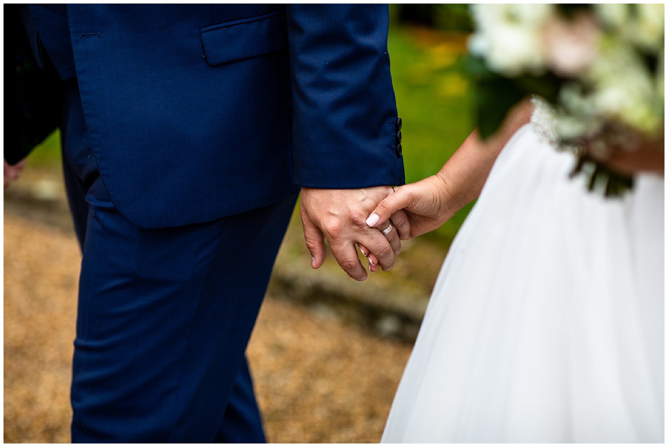 bride and groom walk hand in hand