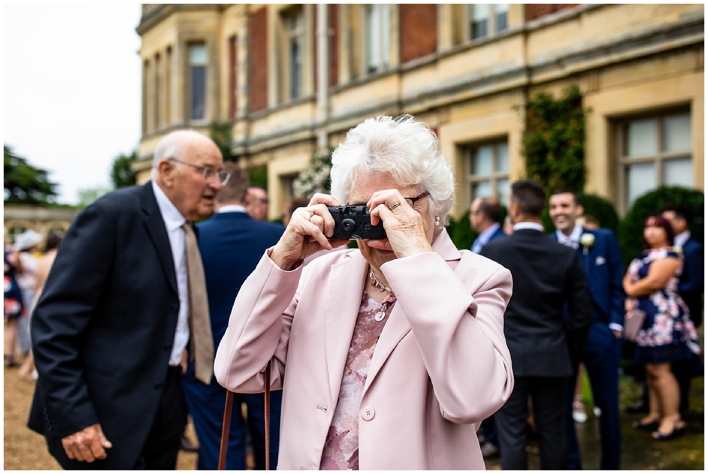 grandma taking photos on disposable camera at somerleyton