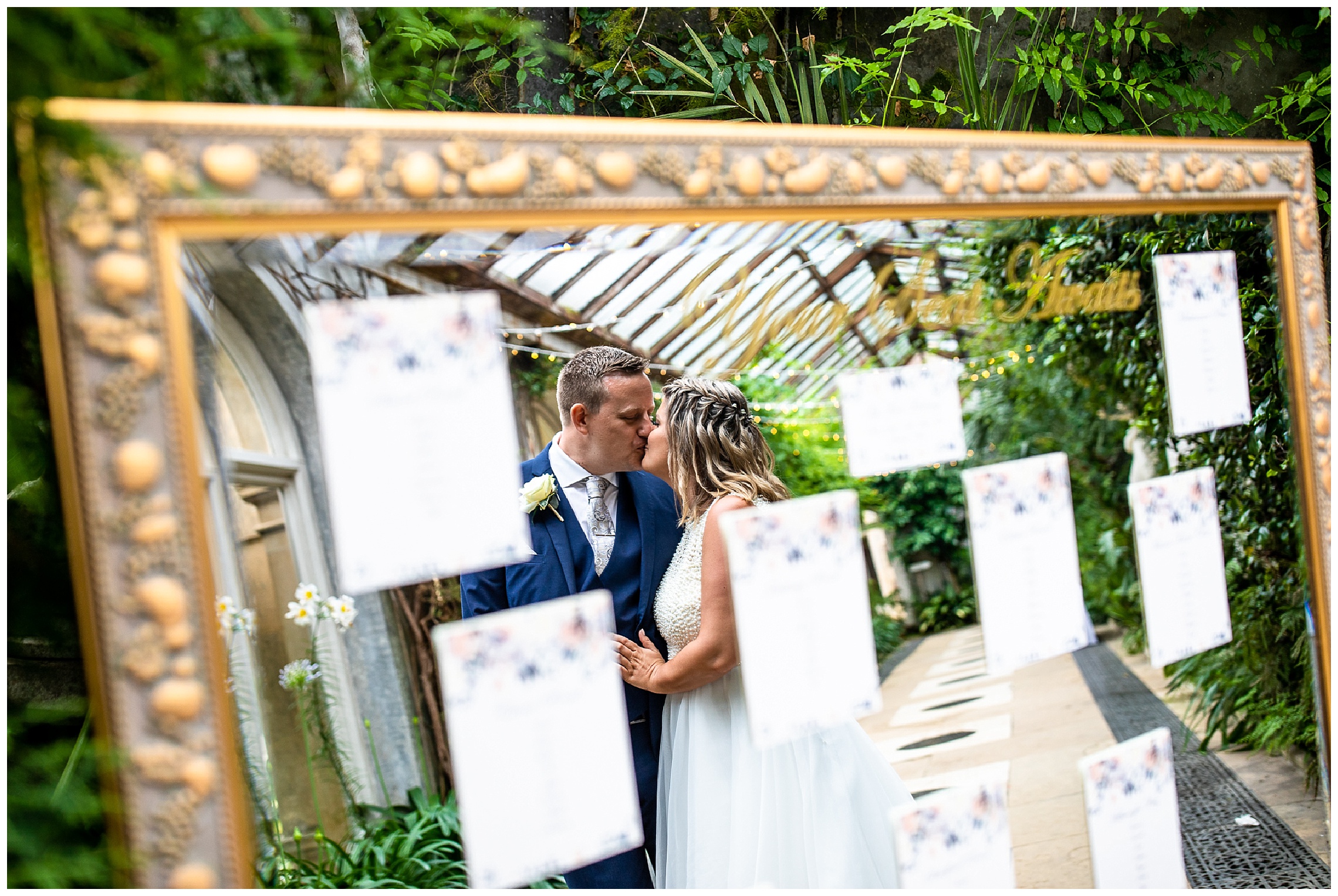 reflection of bride and groom in table plan mirror