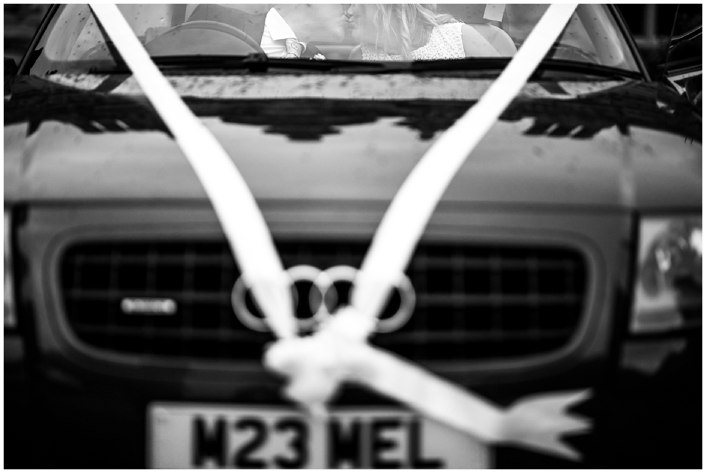 bride and groom kissing in audi