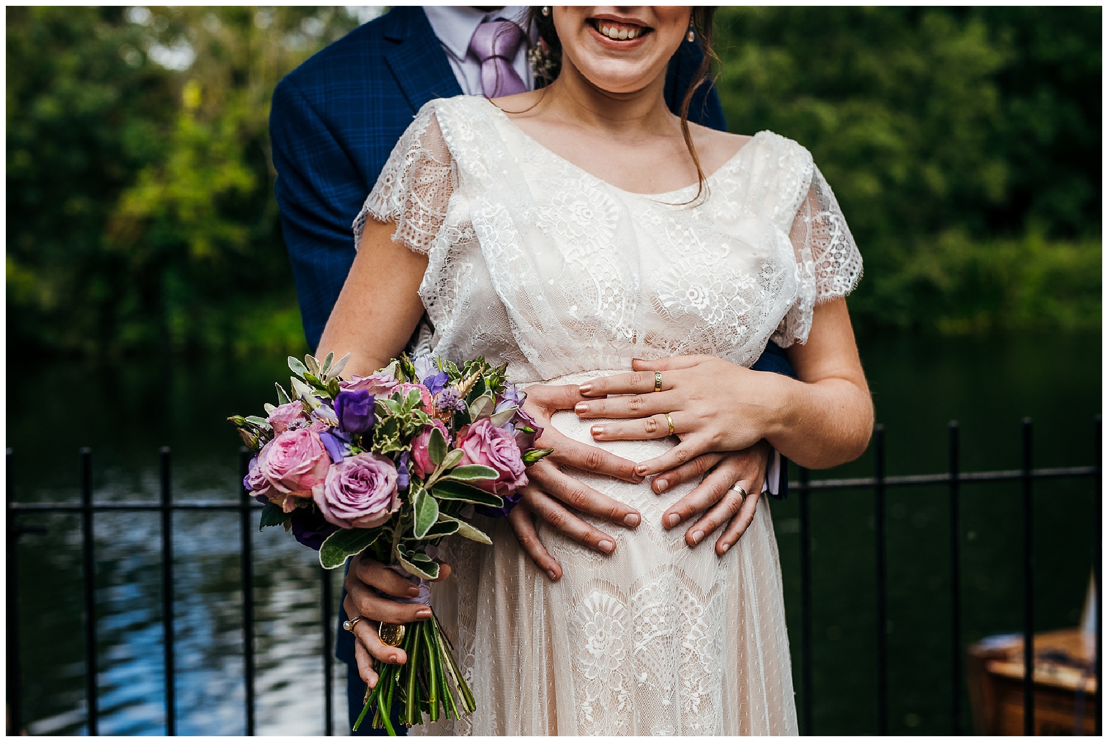 pregnant bride in lace wedding dress, grooms hands and brides hands over bump