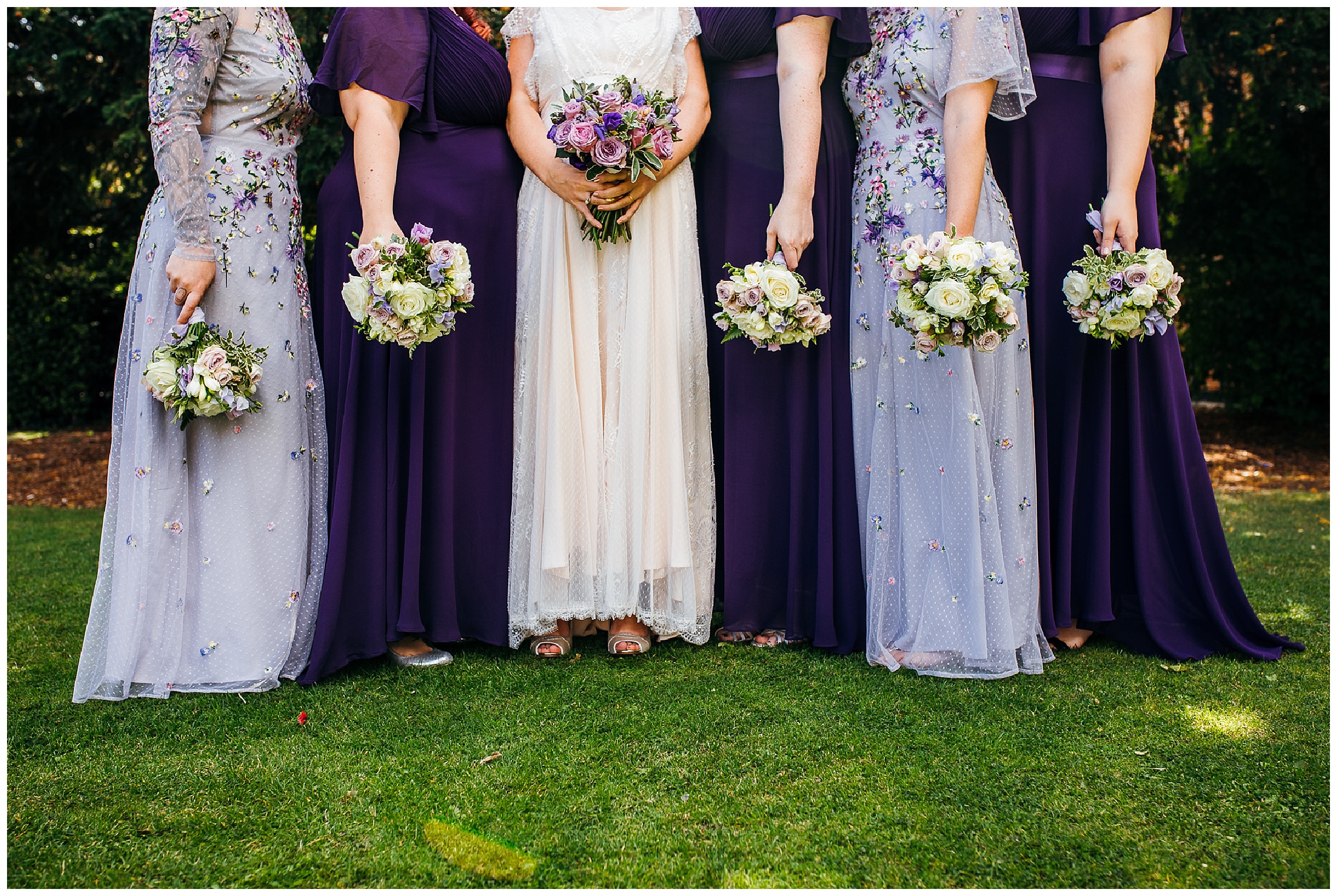 purple bridesmaids dresses of different shades with white bouquets