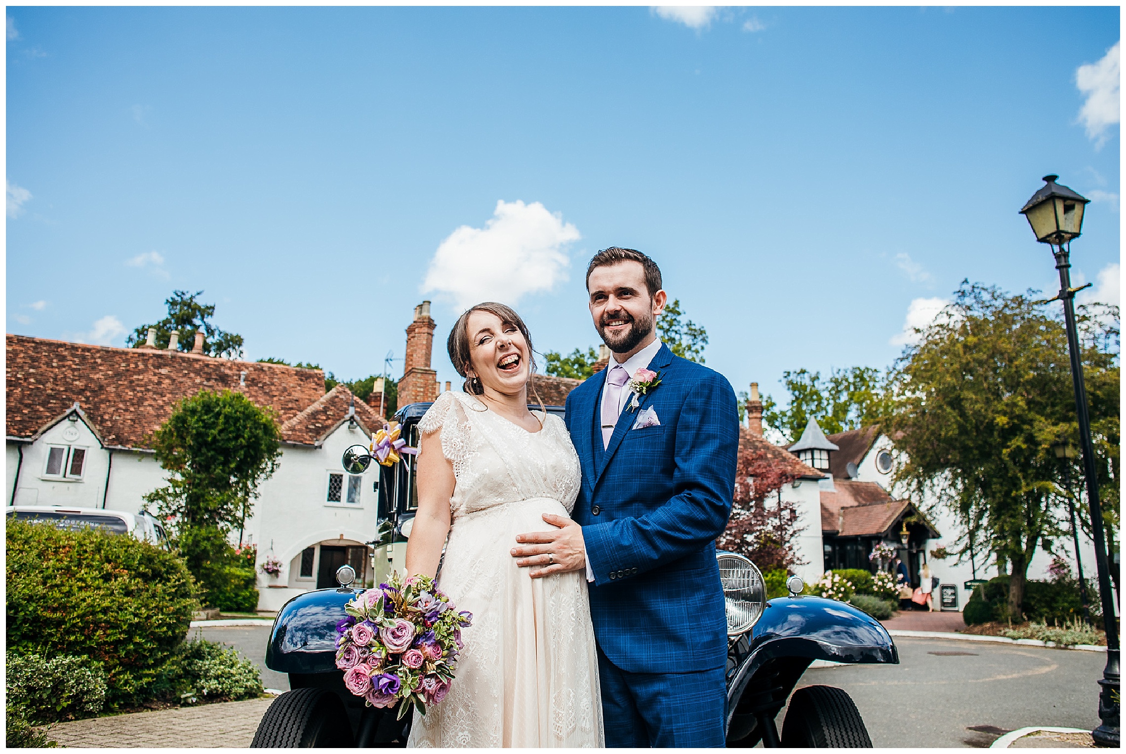 bride and groom laugh together in front of vintage wedding car and barns hotel in Bedfordshire d