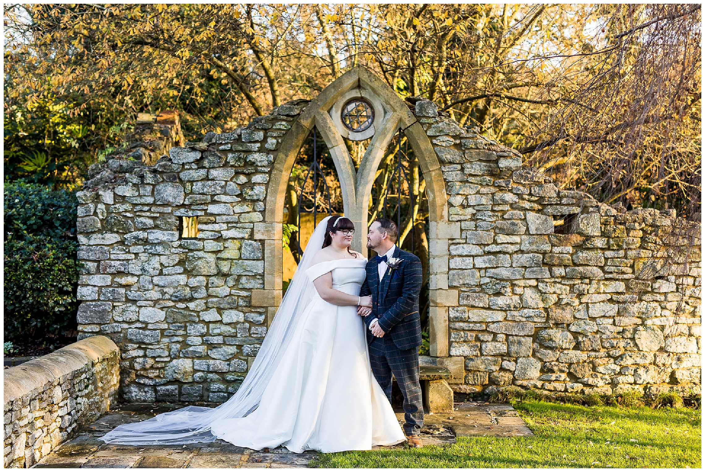 tythe barn in launton outside wall with bride and groom