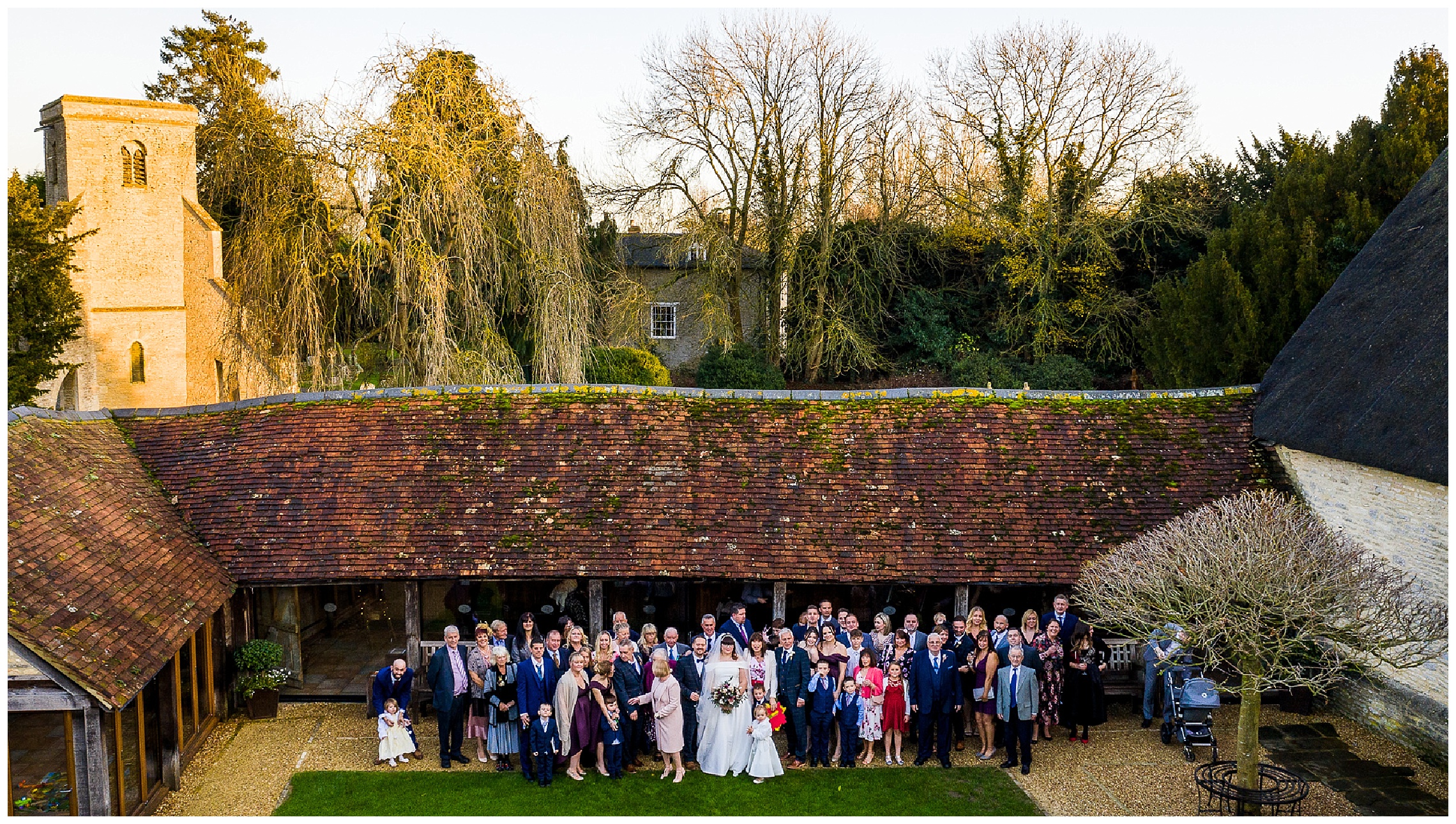 drone shot of wedding guests at tythe barn in launton