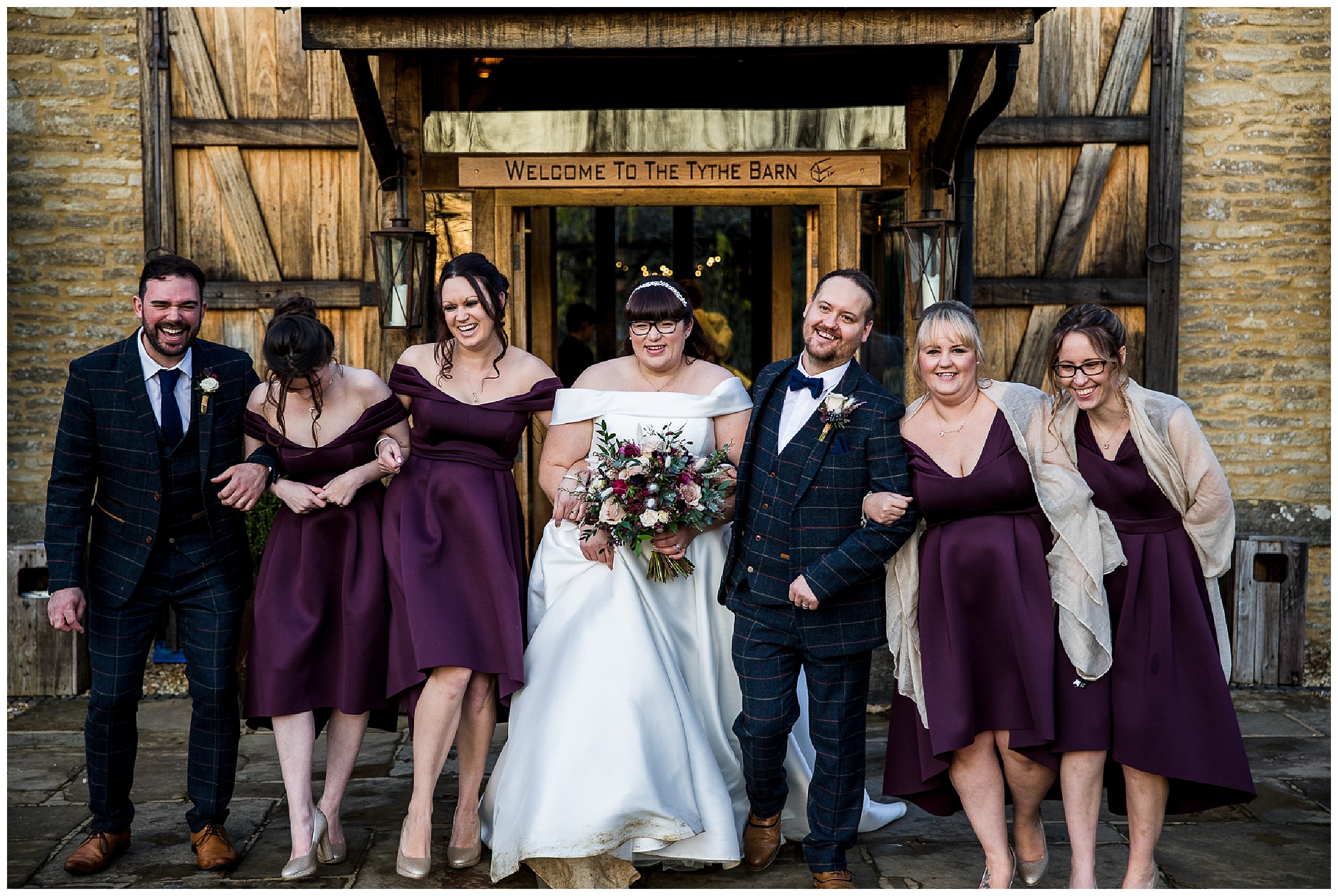 bridesmaids and groomsmen laughing together