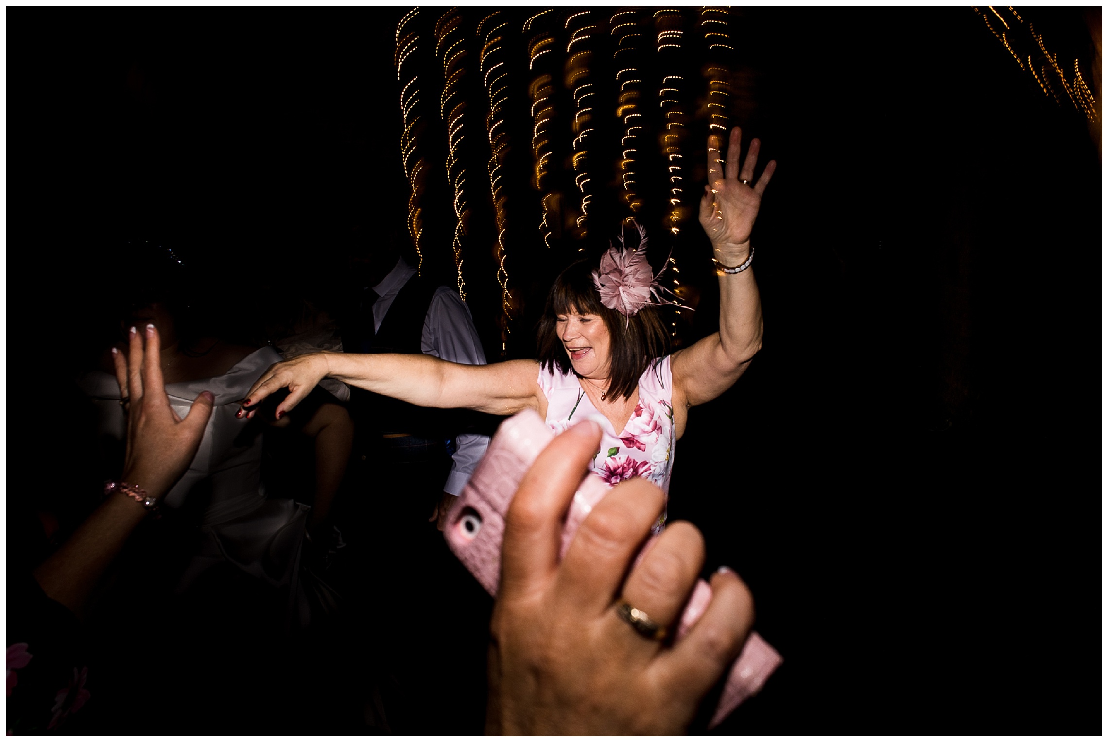 mother of the bride dancing with hands in foreground dancing too