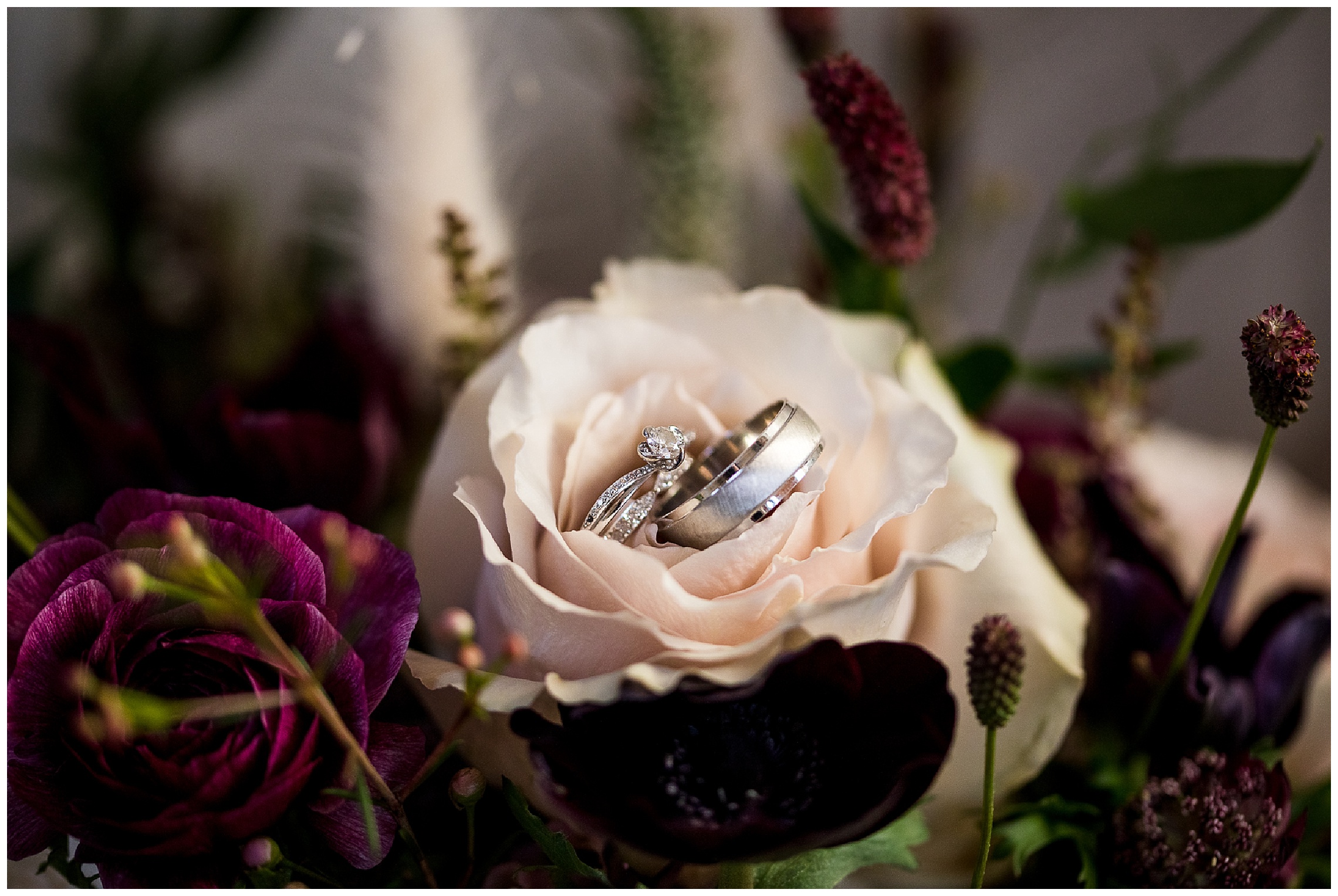Silver wedding rings in pink flower
