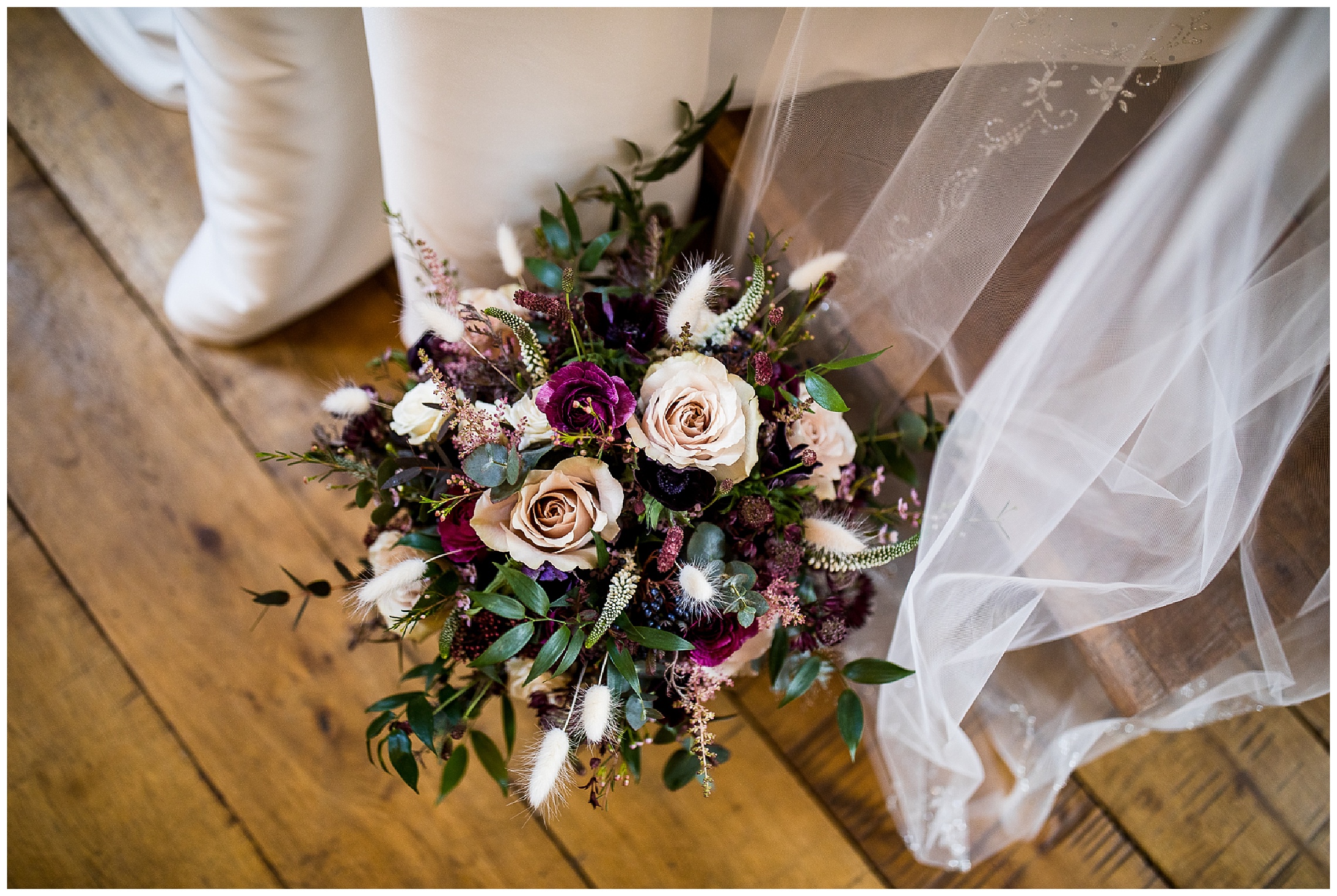 winter bouquet by the flower fairies against white dress and veil