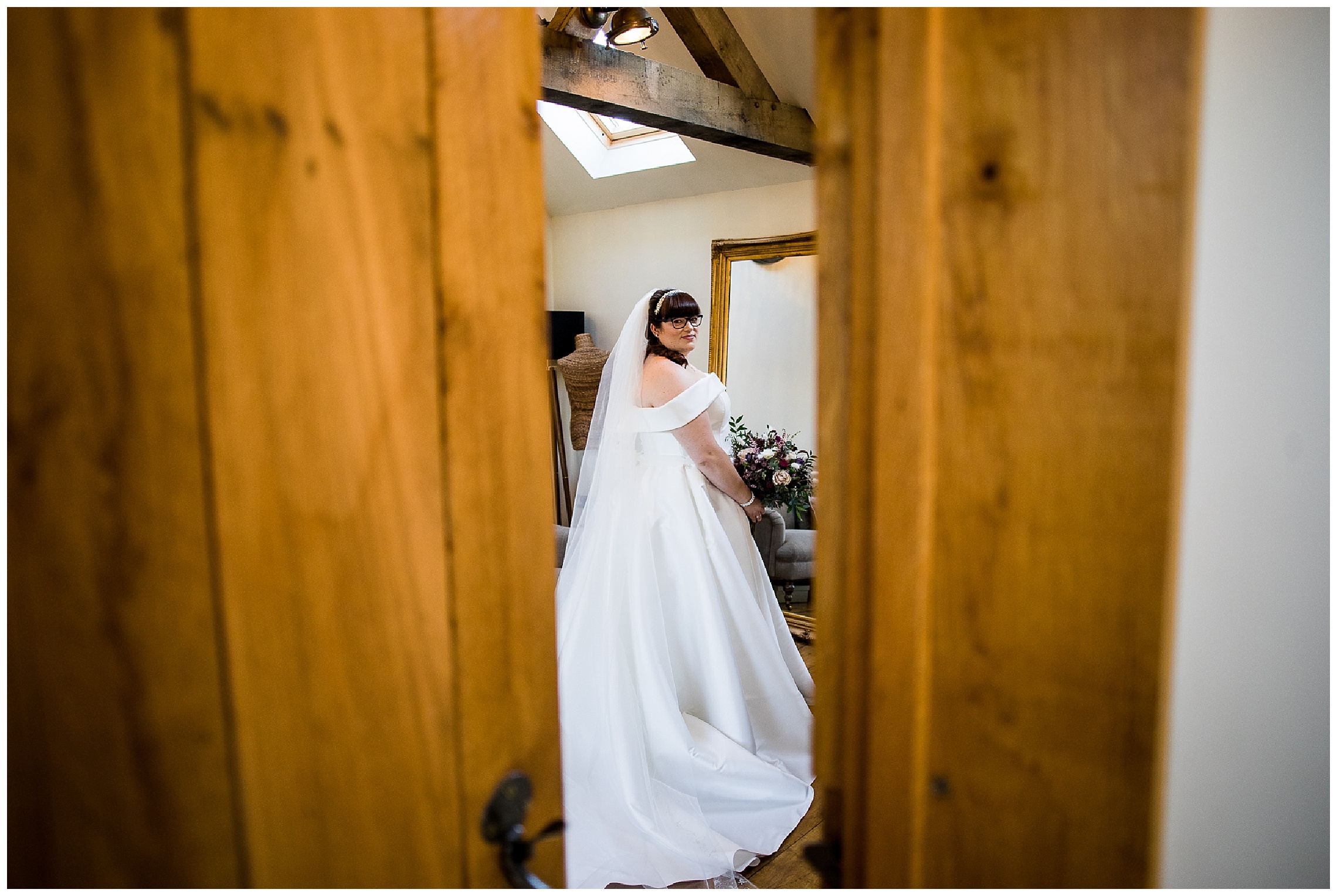 bride in long dress through door crack tythe barn in launton