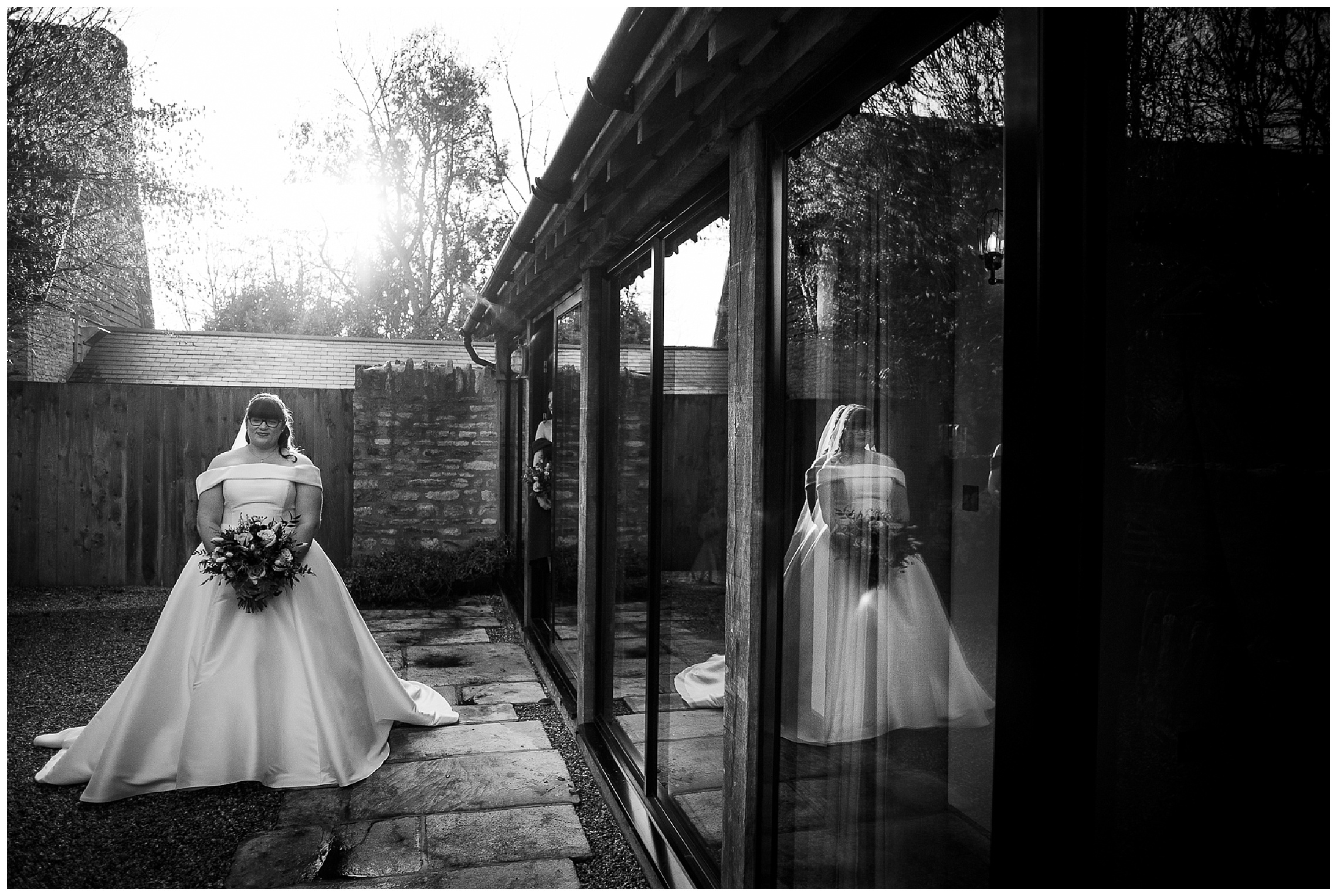 reflection of bride in windows at tythe barn in launton