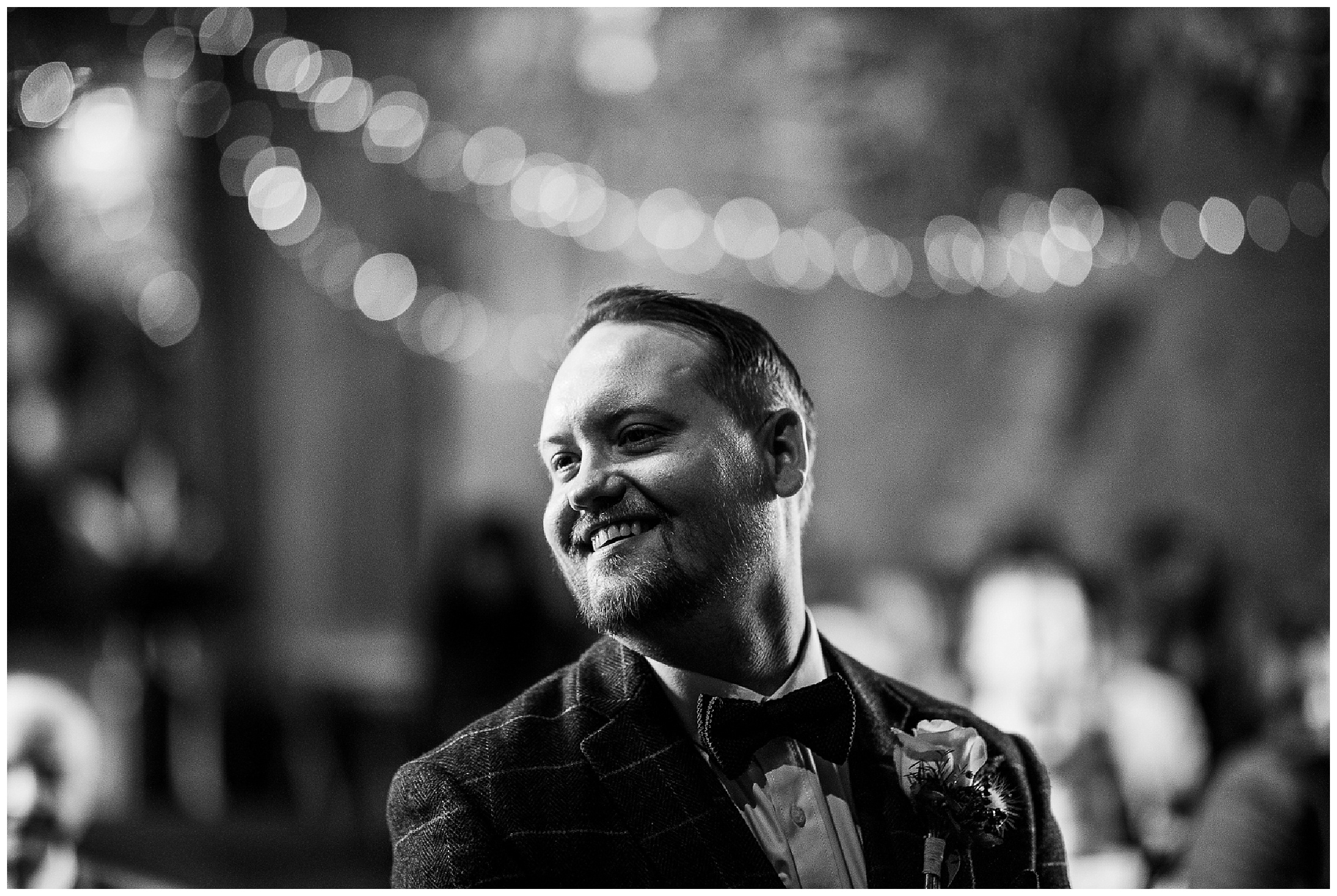 groom smiling at end of aisle in tythe barn in launton