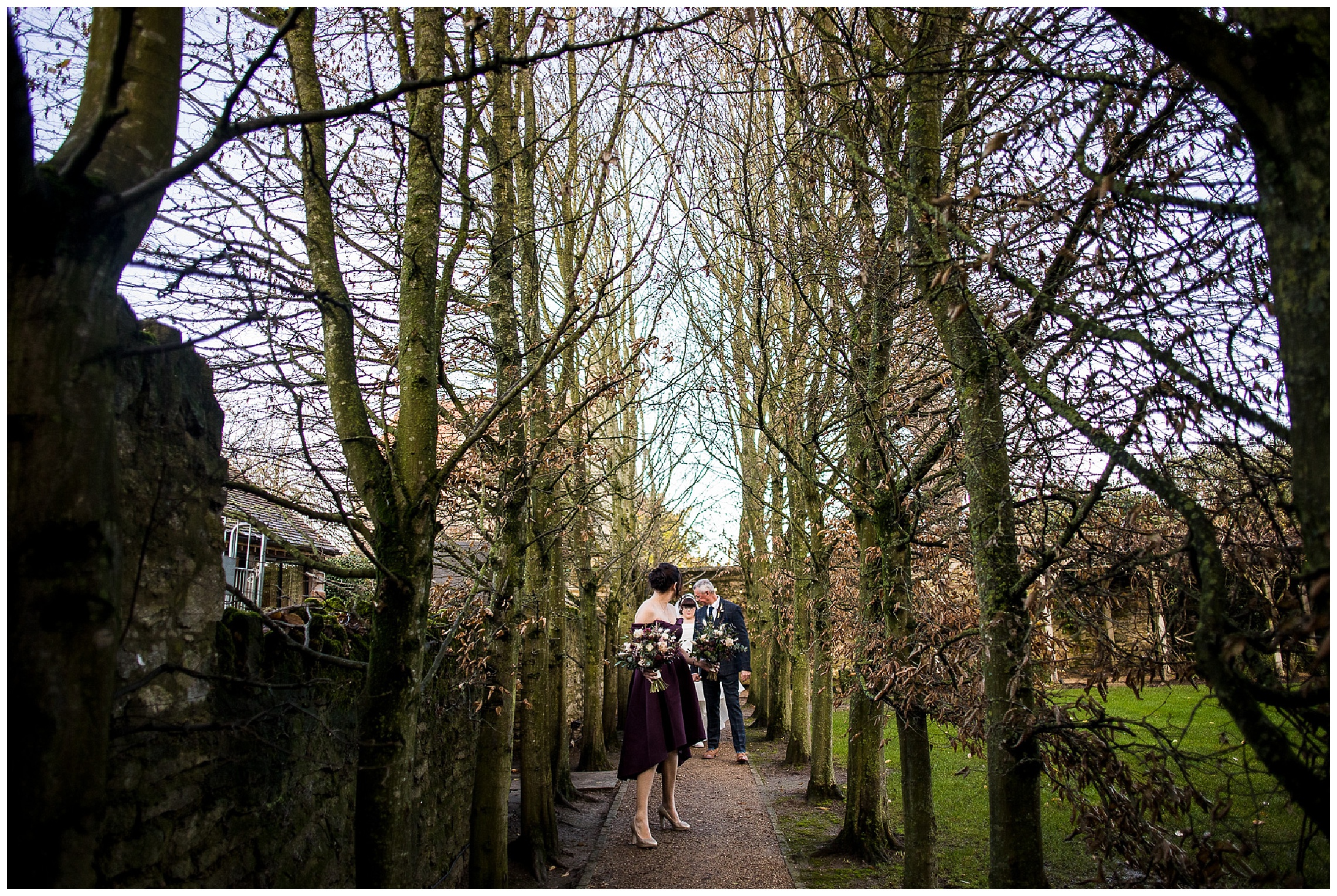 bride and father of the bride walking through tunnel of trees