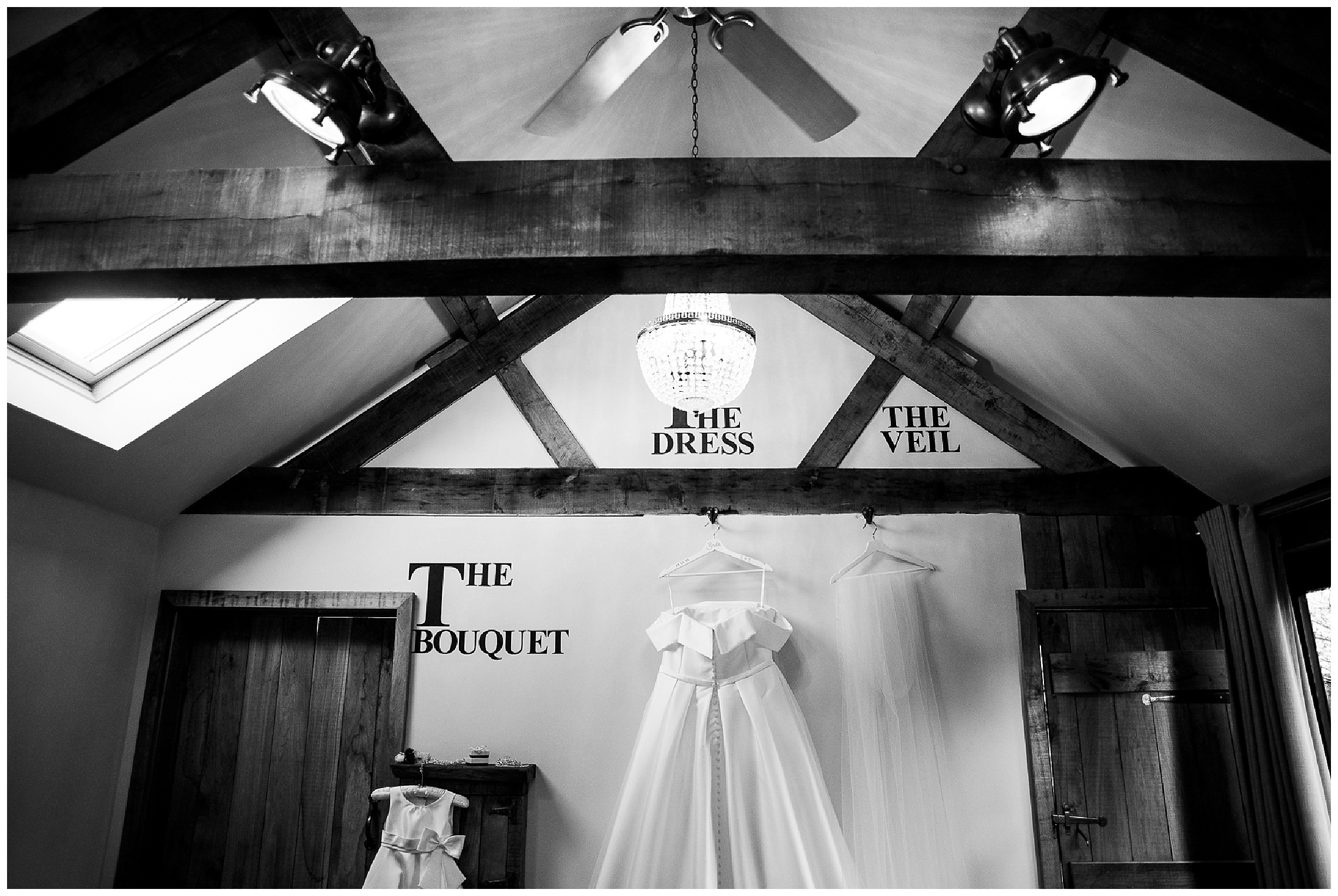 bridal nook in tythe barn launton, dress hanging on wall with flower girls dress next to it