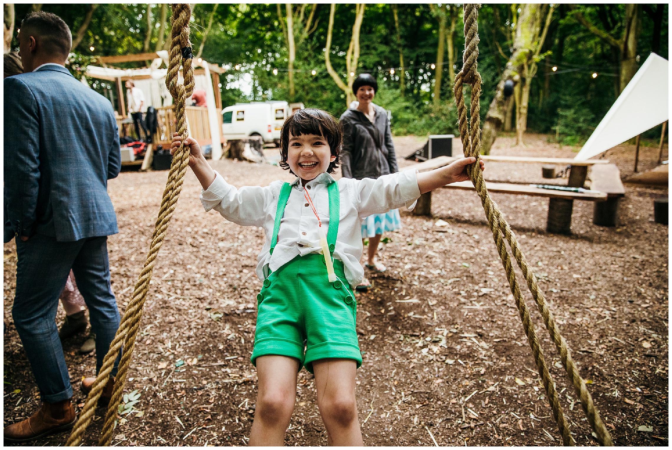 child in green lederhosen on tree swing at lilas wood