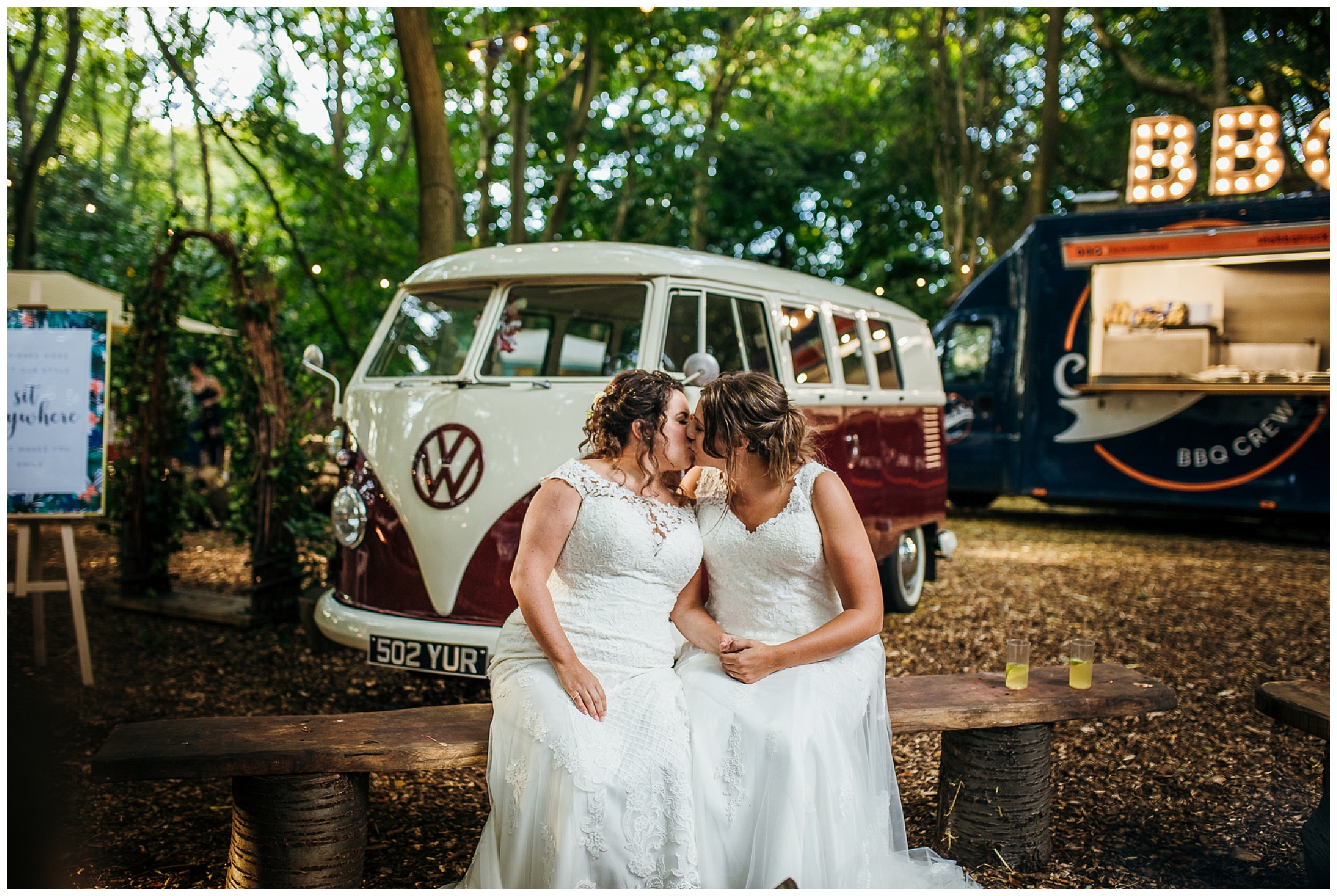brides kiss on benches in front of VW van