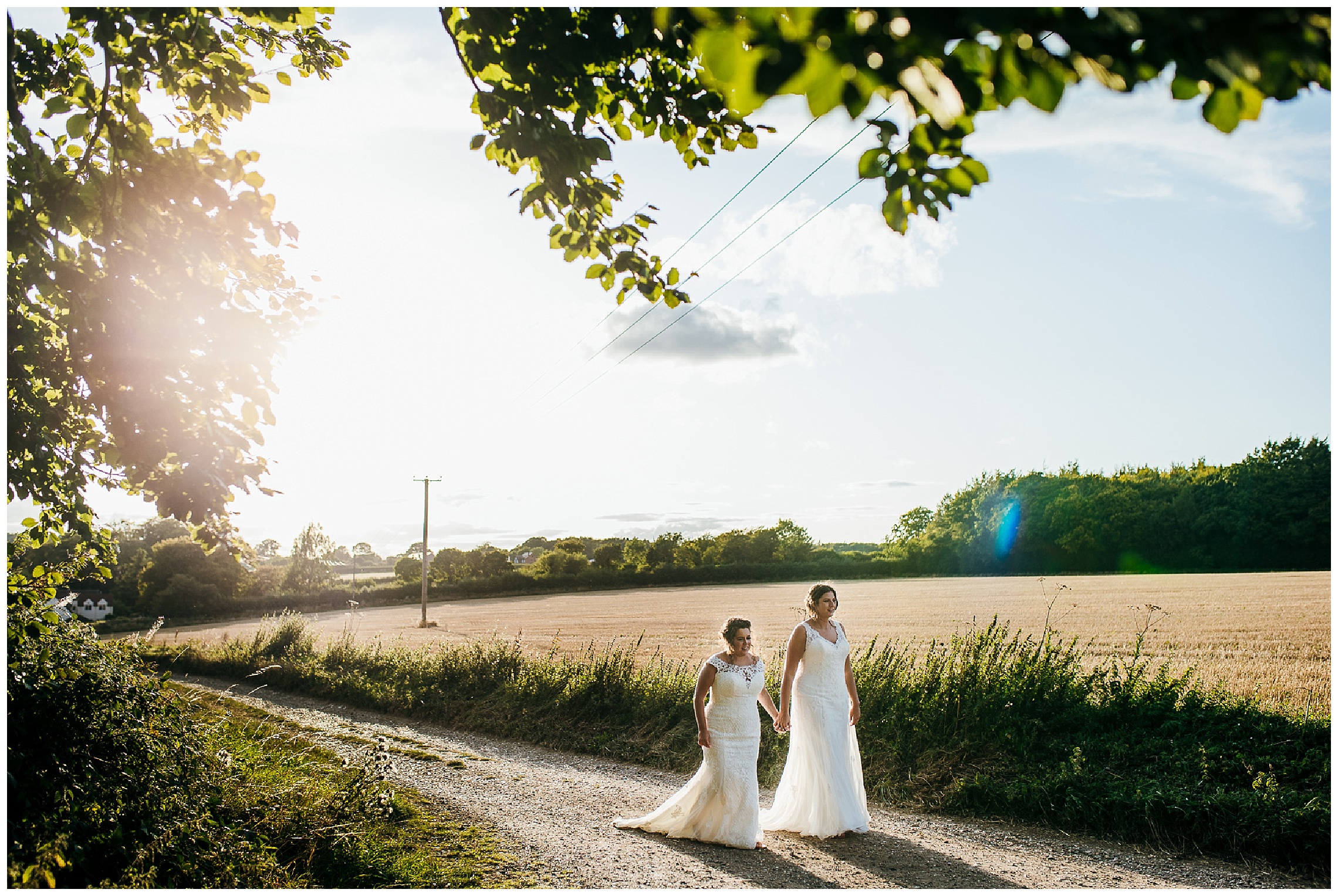 brides walk together at sunset