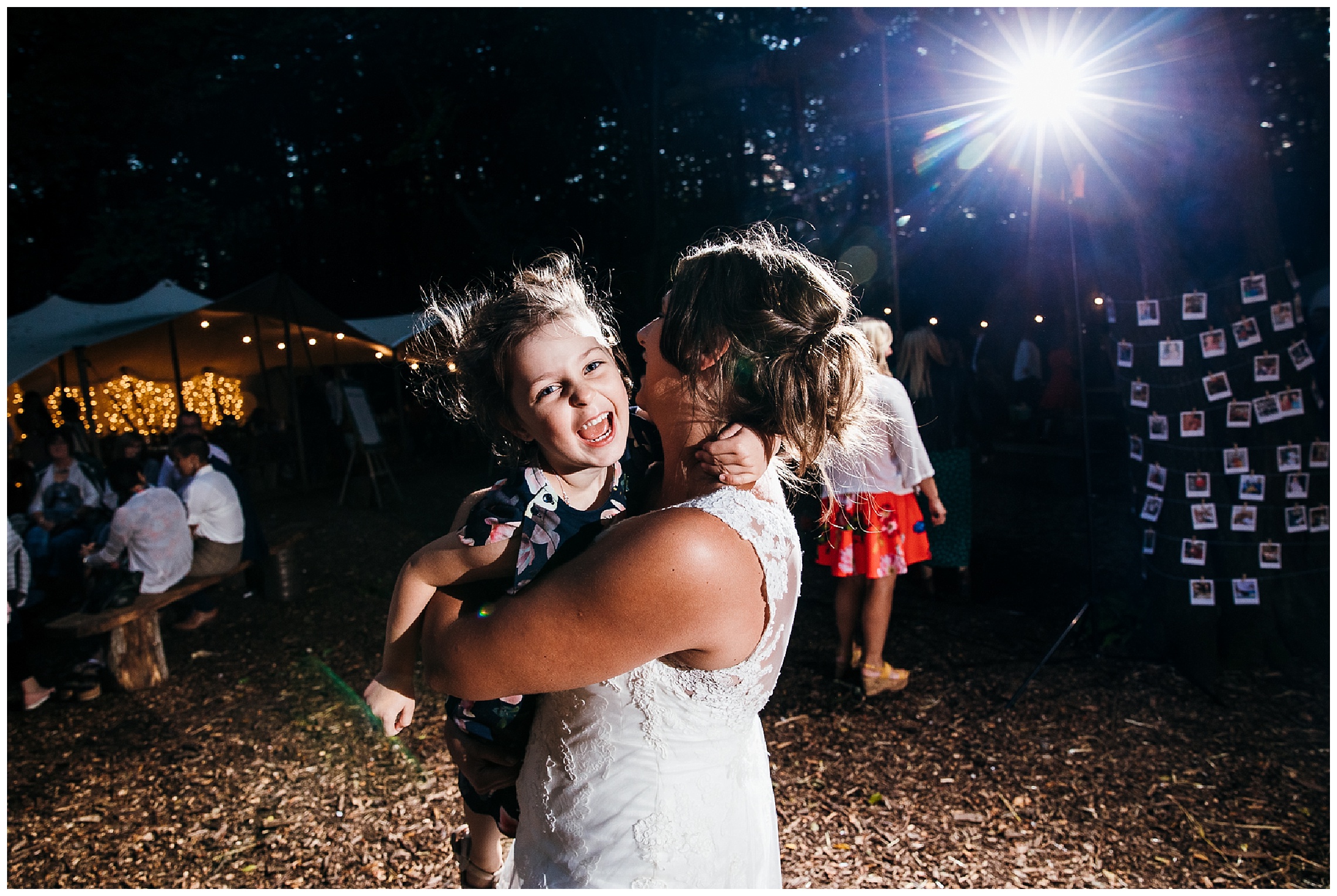 bride cuddling her niece on dance floor