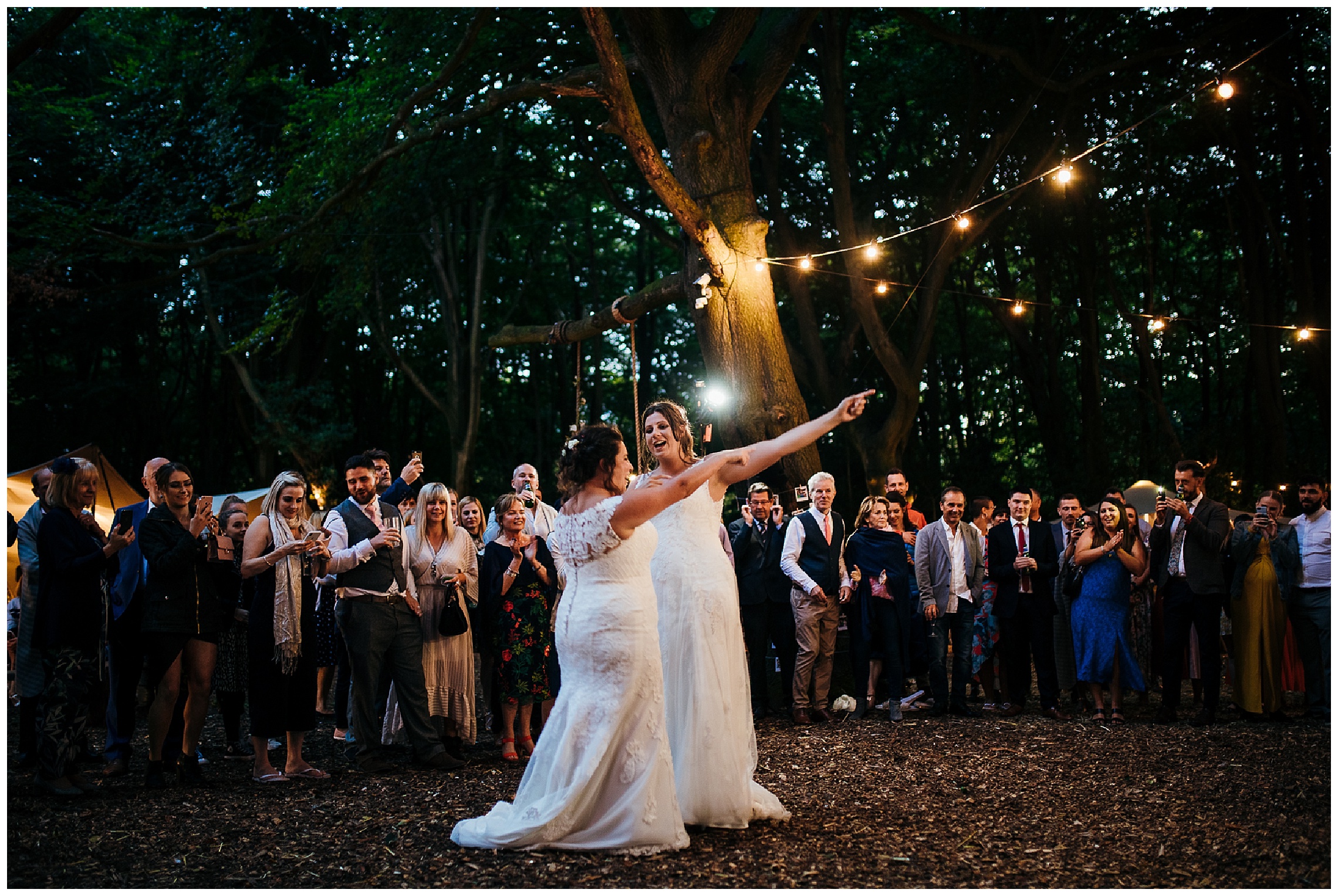 brides dance and sing along to like an arrow at outdoor woodland wedding