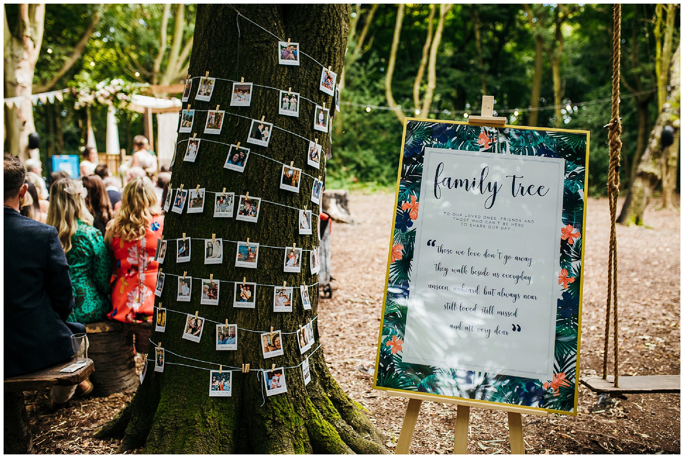 tree with pictures of family stuck to it and a sign labelling it as a family tree