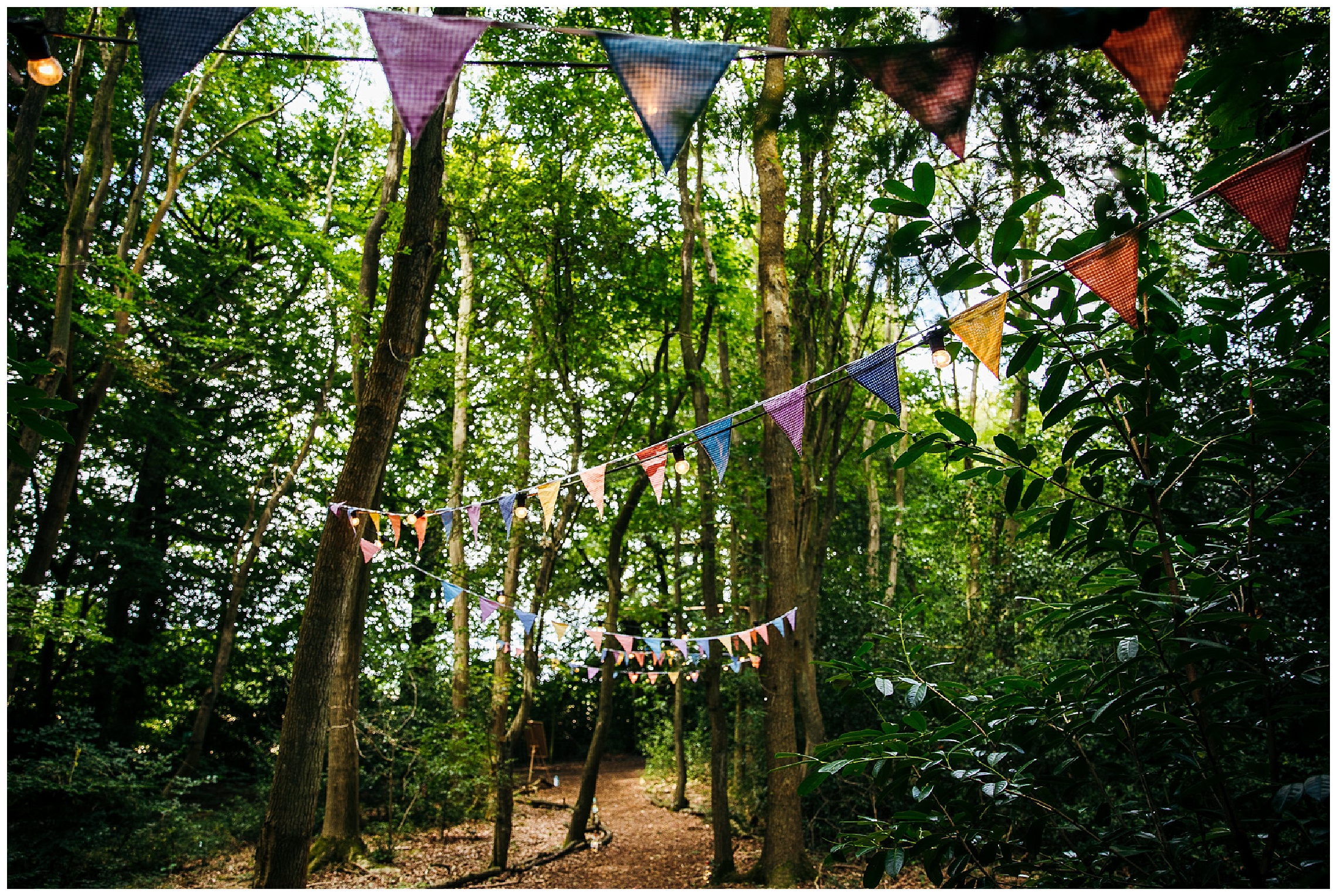 woodland weddings entrance with colourful bunting