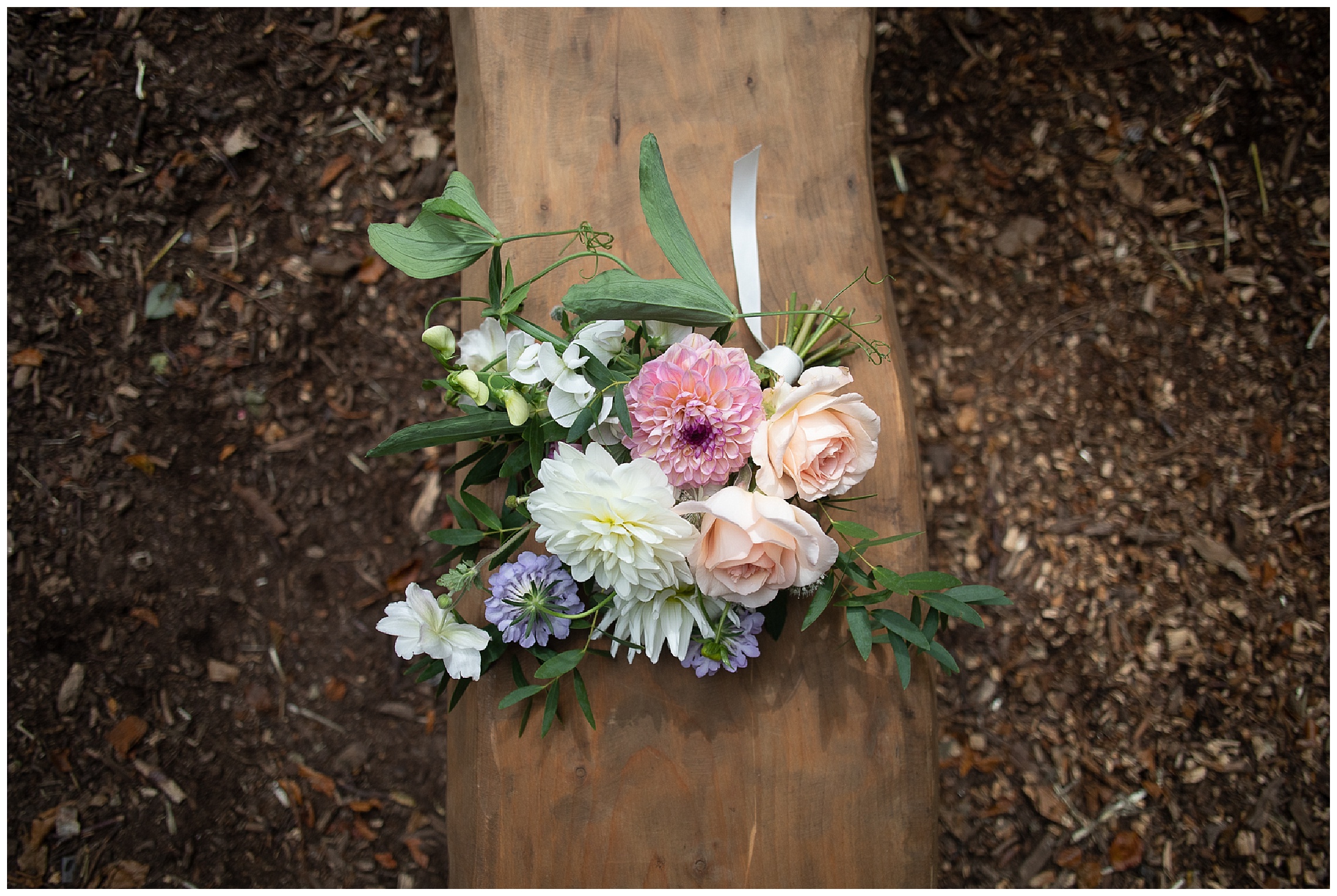 loosely hand tied wedding bouquet with english garden style flowers