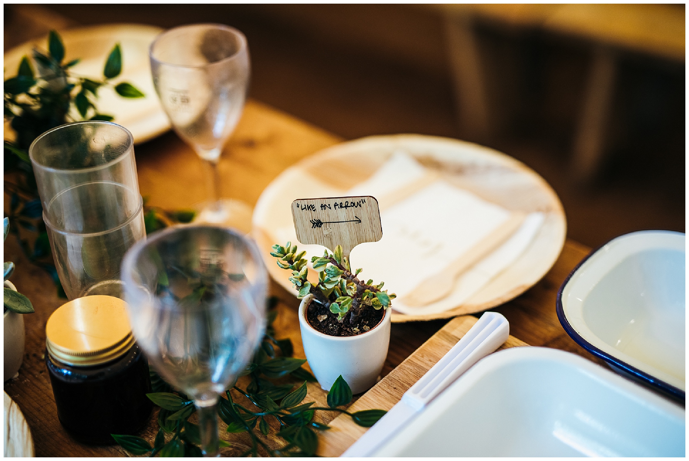 wedding favours with wooden plates and succulents with song lyrics in at woodland weddings tipi venue