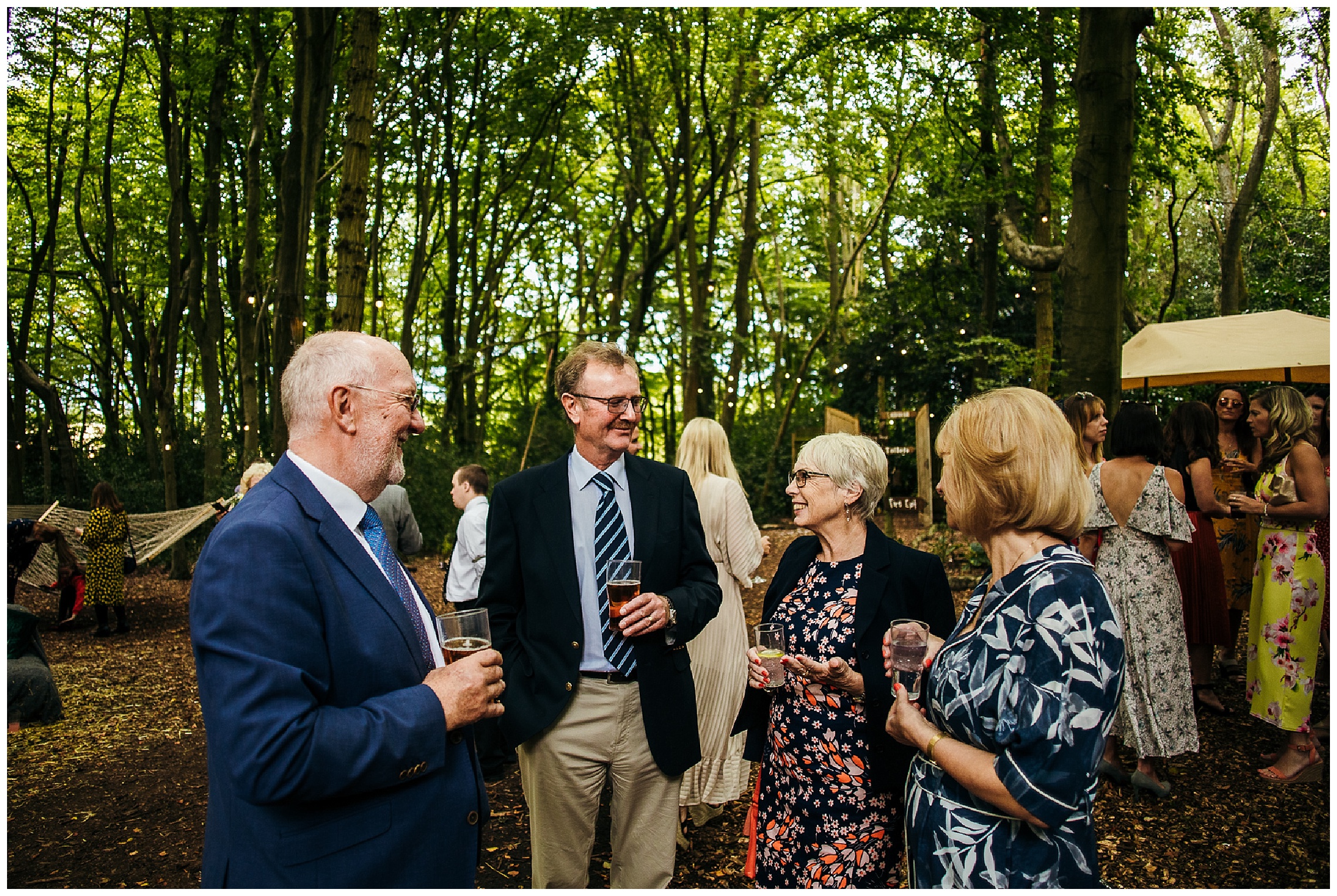 wedding guests mingle in woodland weddings venue
