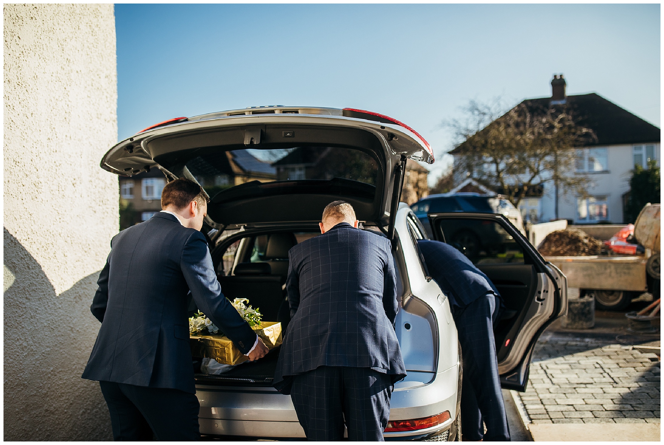 groomsmen packing up boot of car