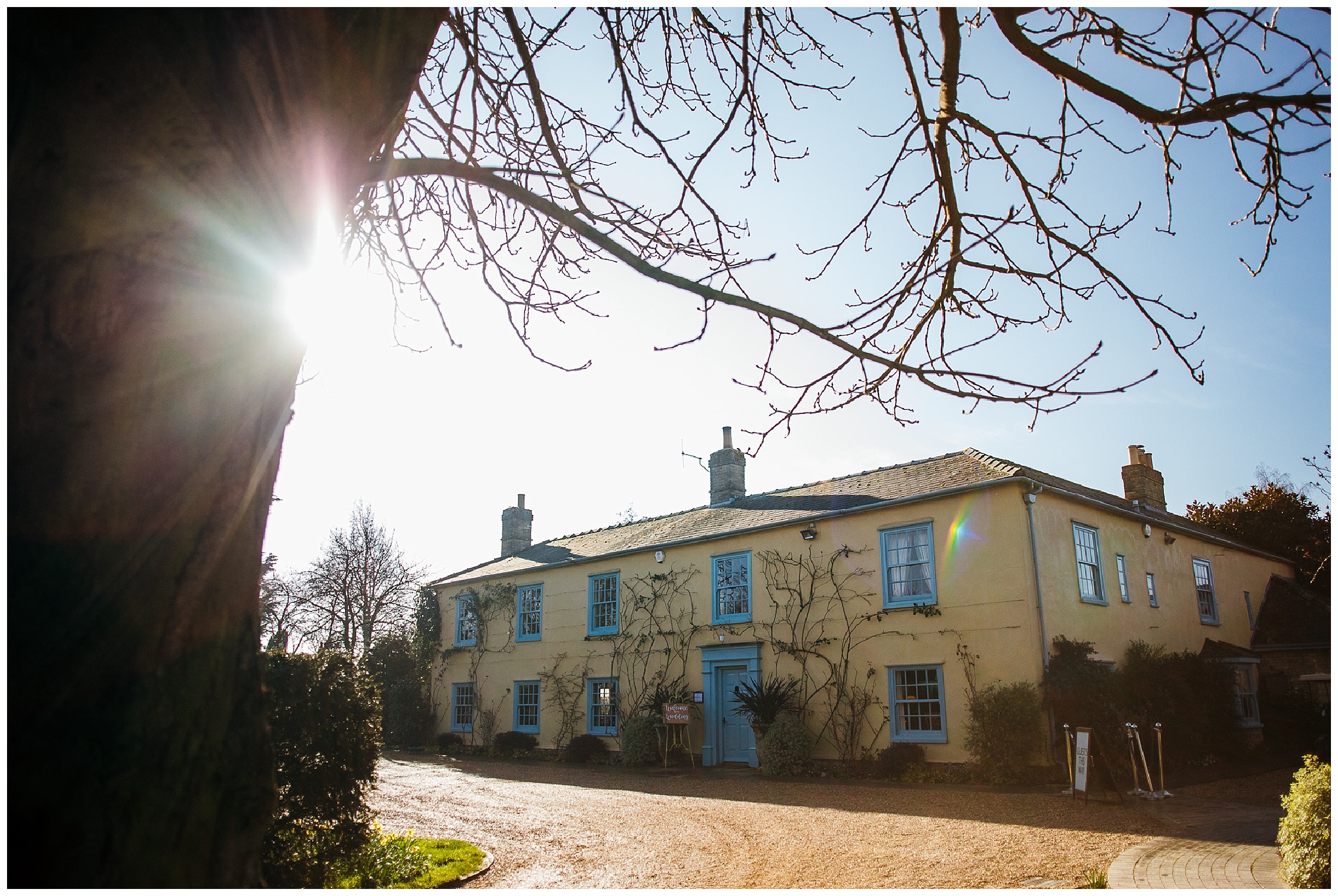 south farm wedding venue, blue and yellow manor house in low winter sun