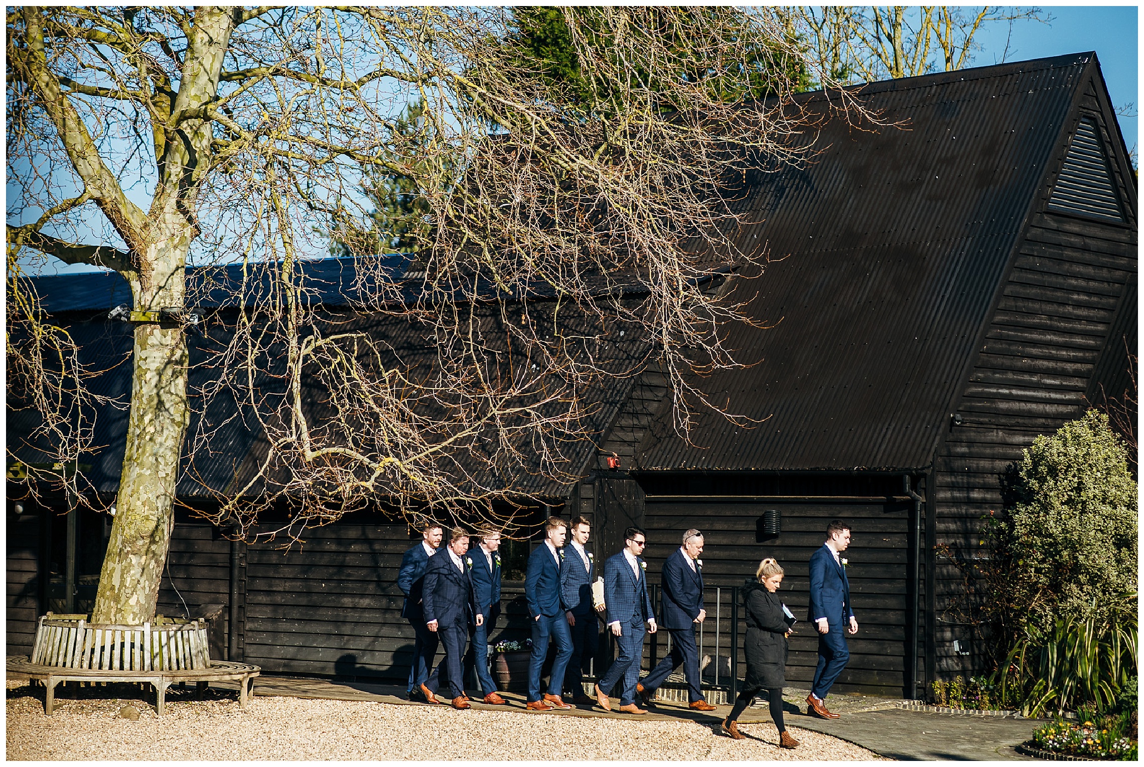 groomsmen walking together across venue grounds