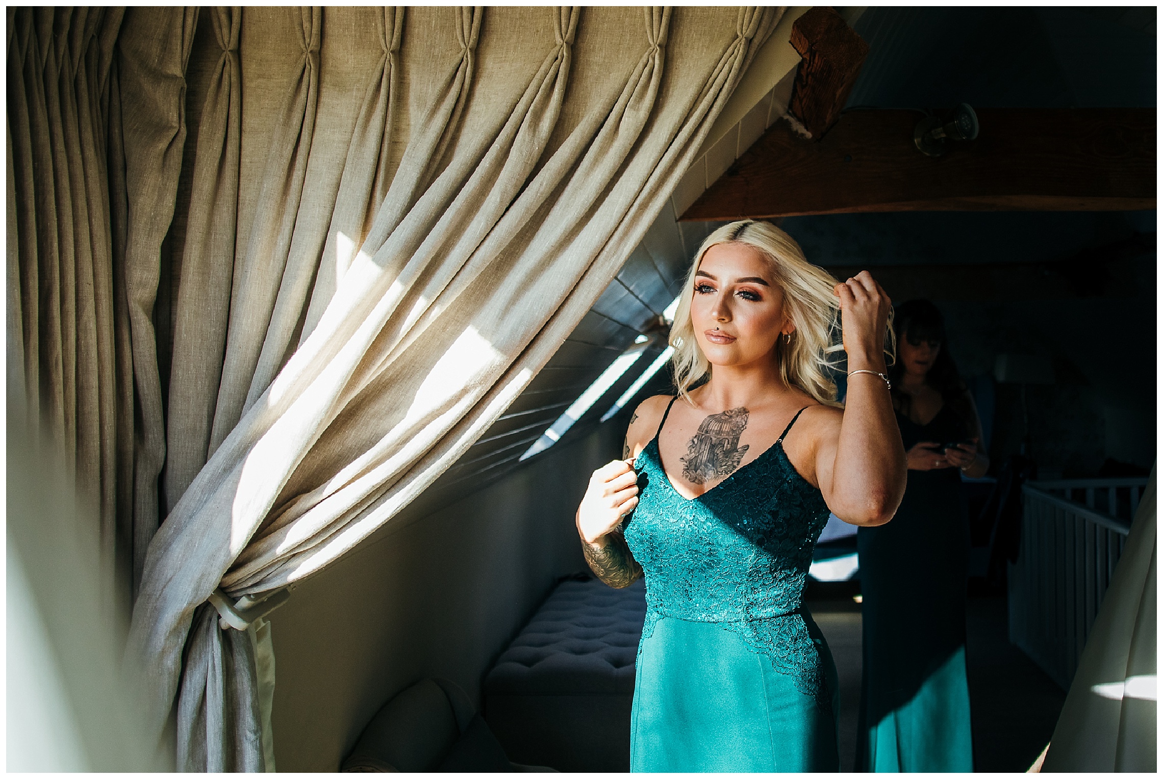 blonde bridesmaid in green dress and tattoos on chest