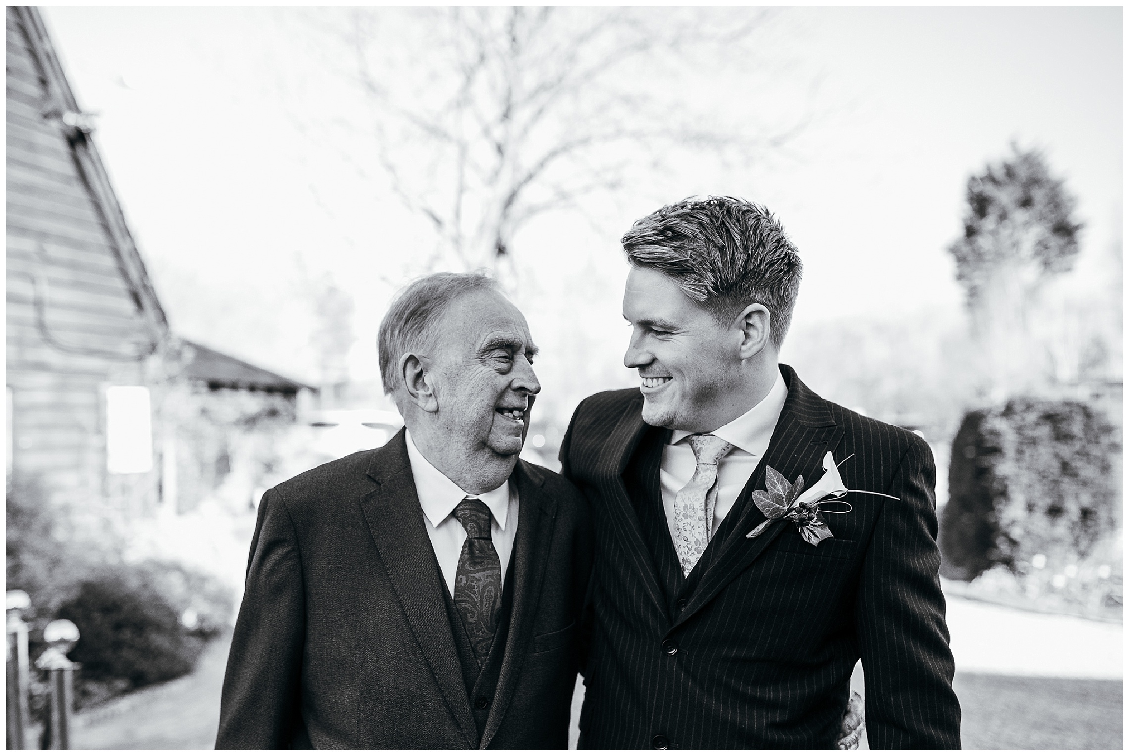 groom and granddad looking at each other at south farm