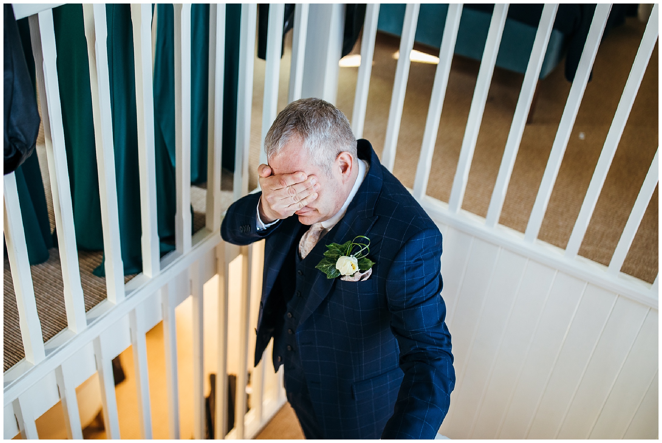 father of the bride ascending stairs and covering his eyes