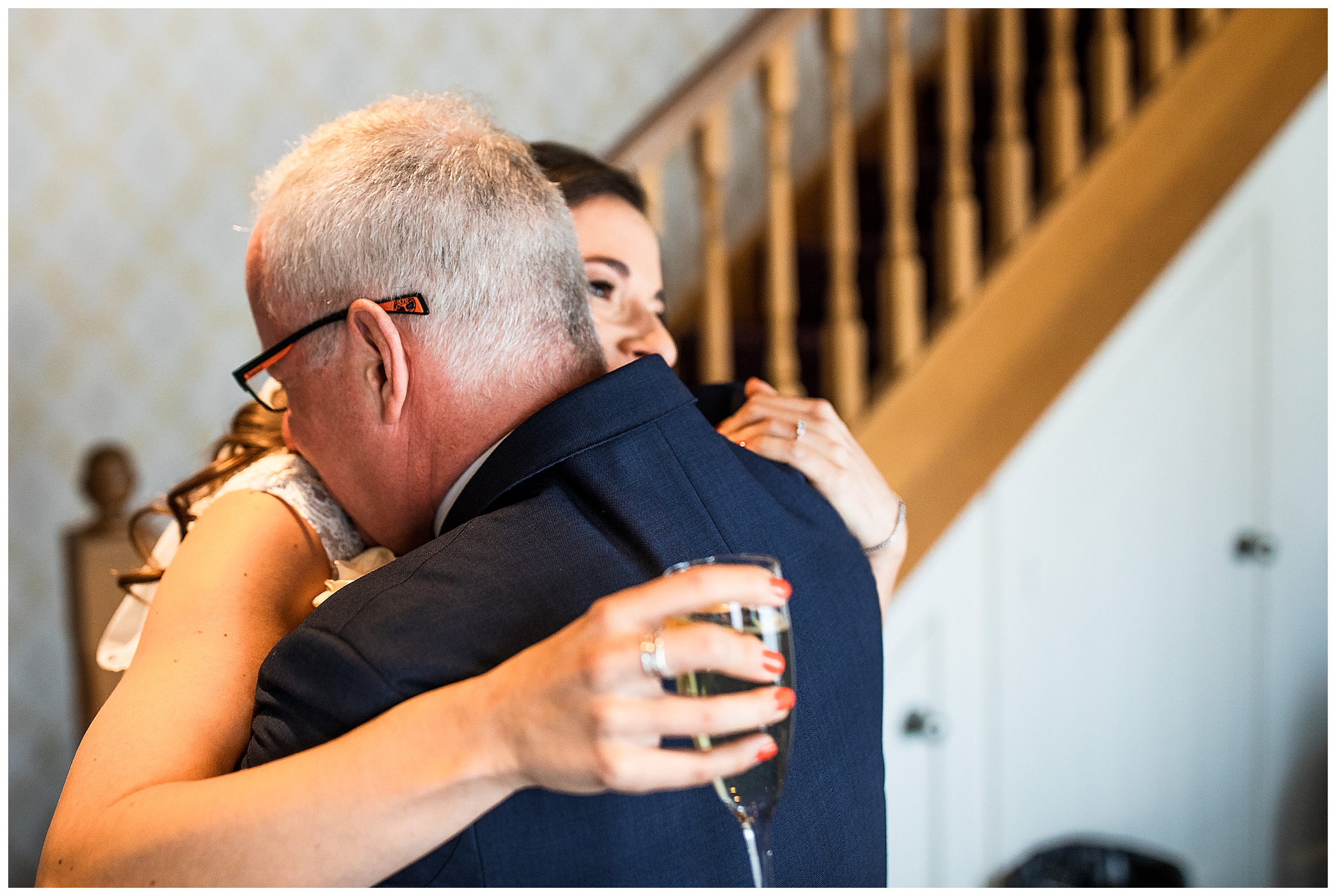 bride and father of the bride hugging